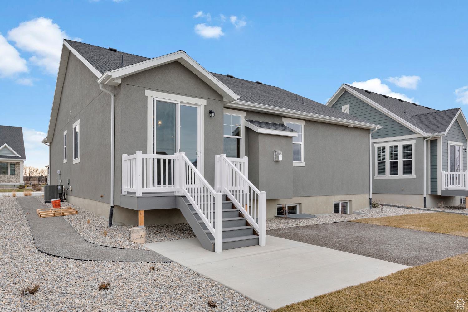 View of front facade featuring central AC unit and a patio area