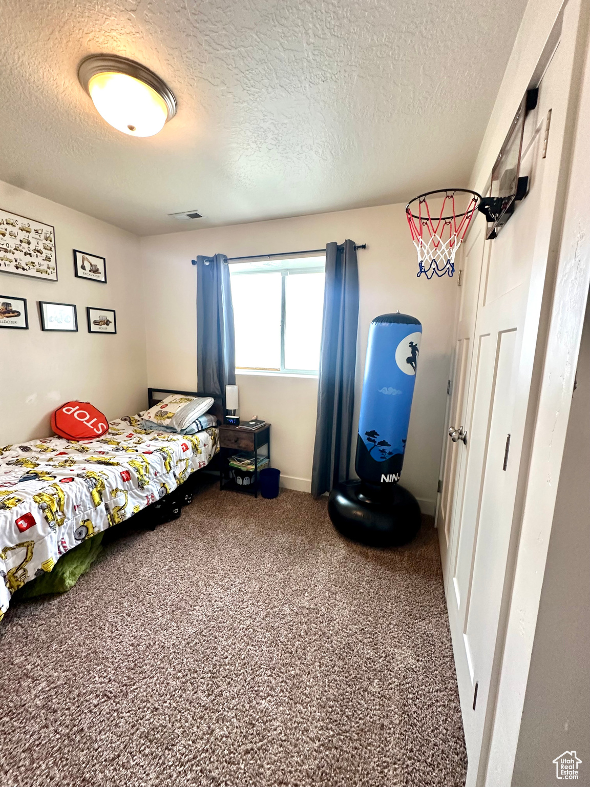 Carpeted bedroom featuring a textured ceiling