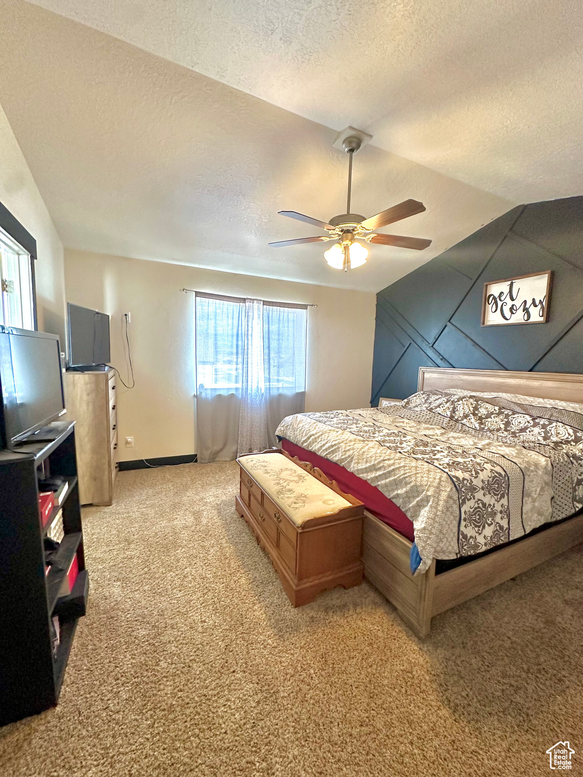 Master Bedroom featuring lofted ceiling, ceiling fan, and a textured ceiling