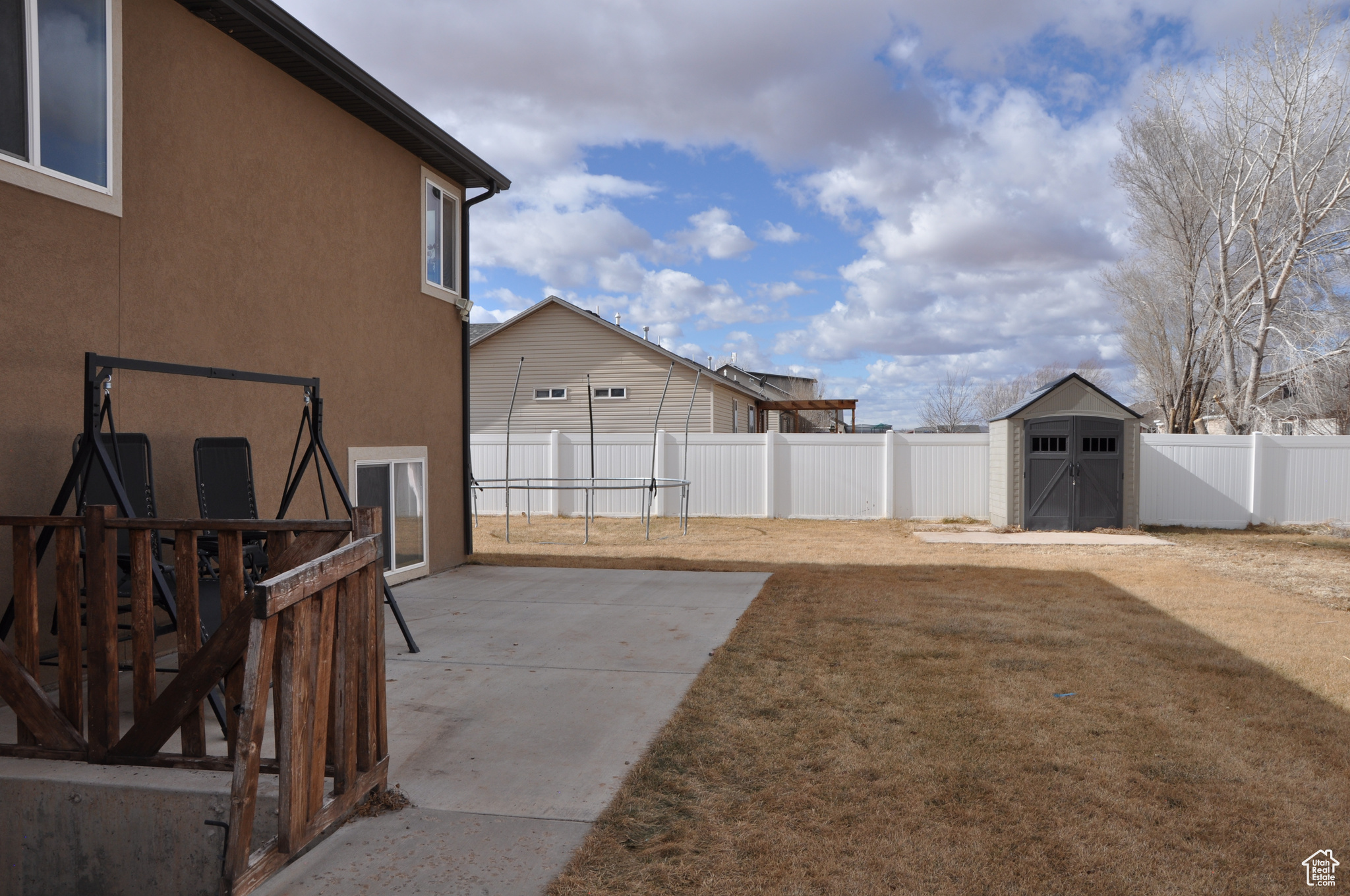 View of yard with a shed and a patio area