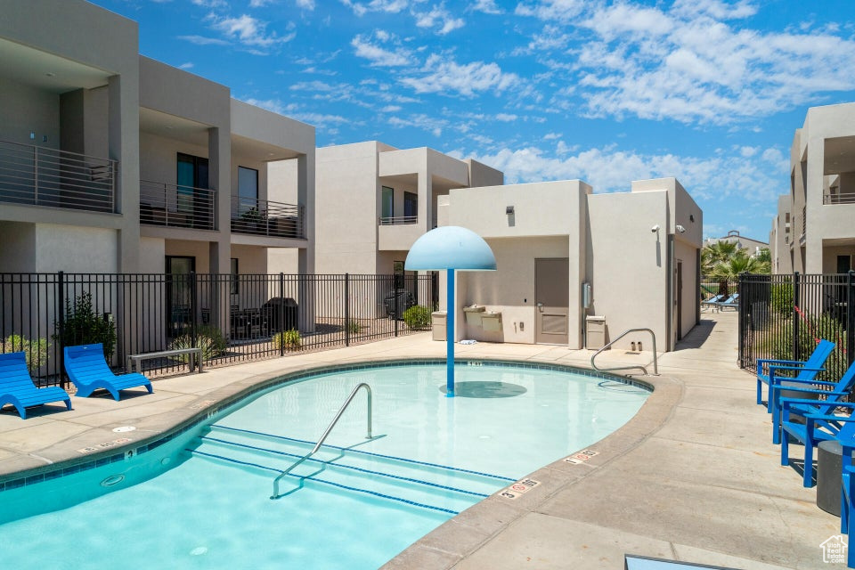 View of swimming pool with an outdoor kitchen and a patio area