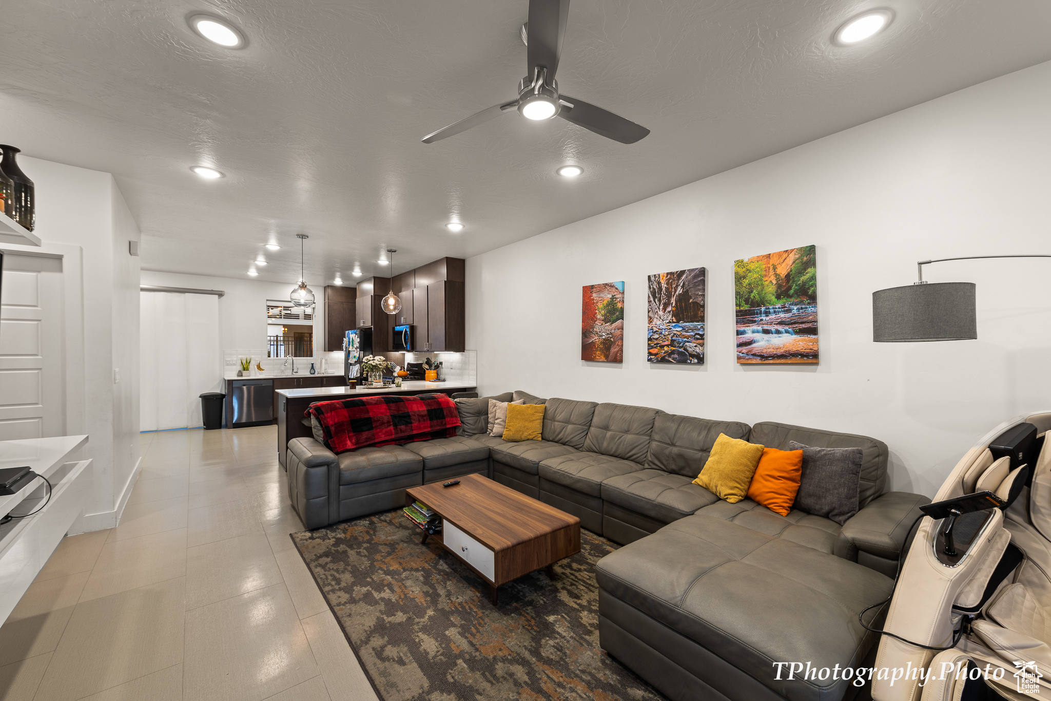 Living room featuring a textured ceiling and ceiling fan