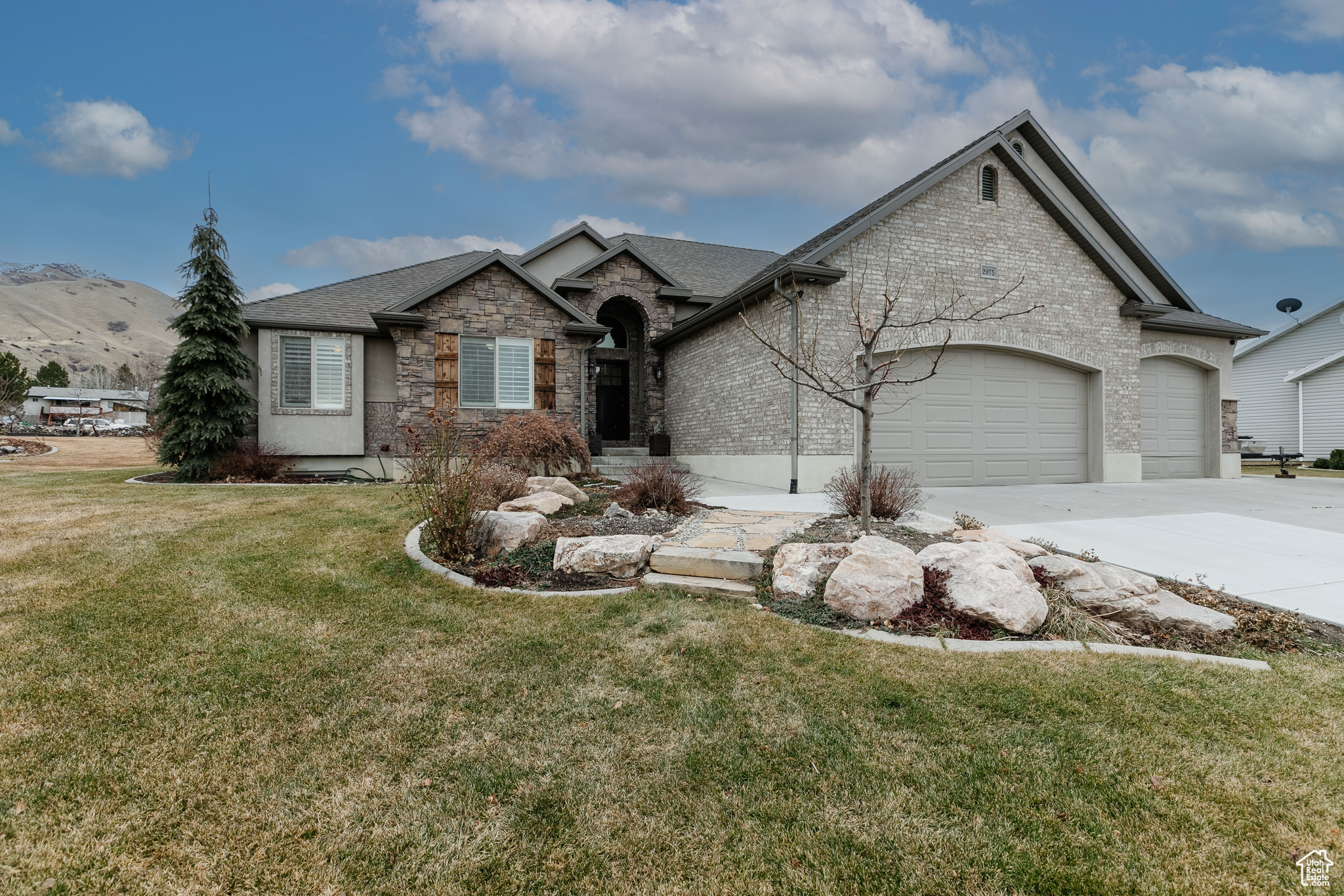 View of front of home with a garage and a front lawn