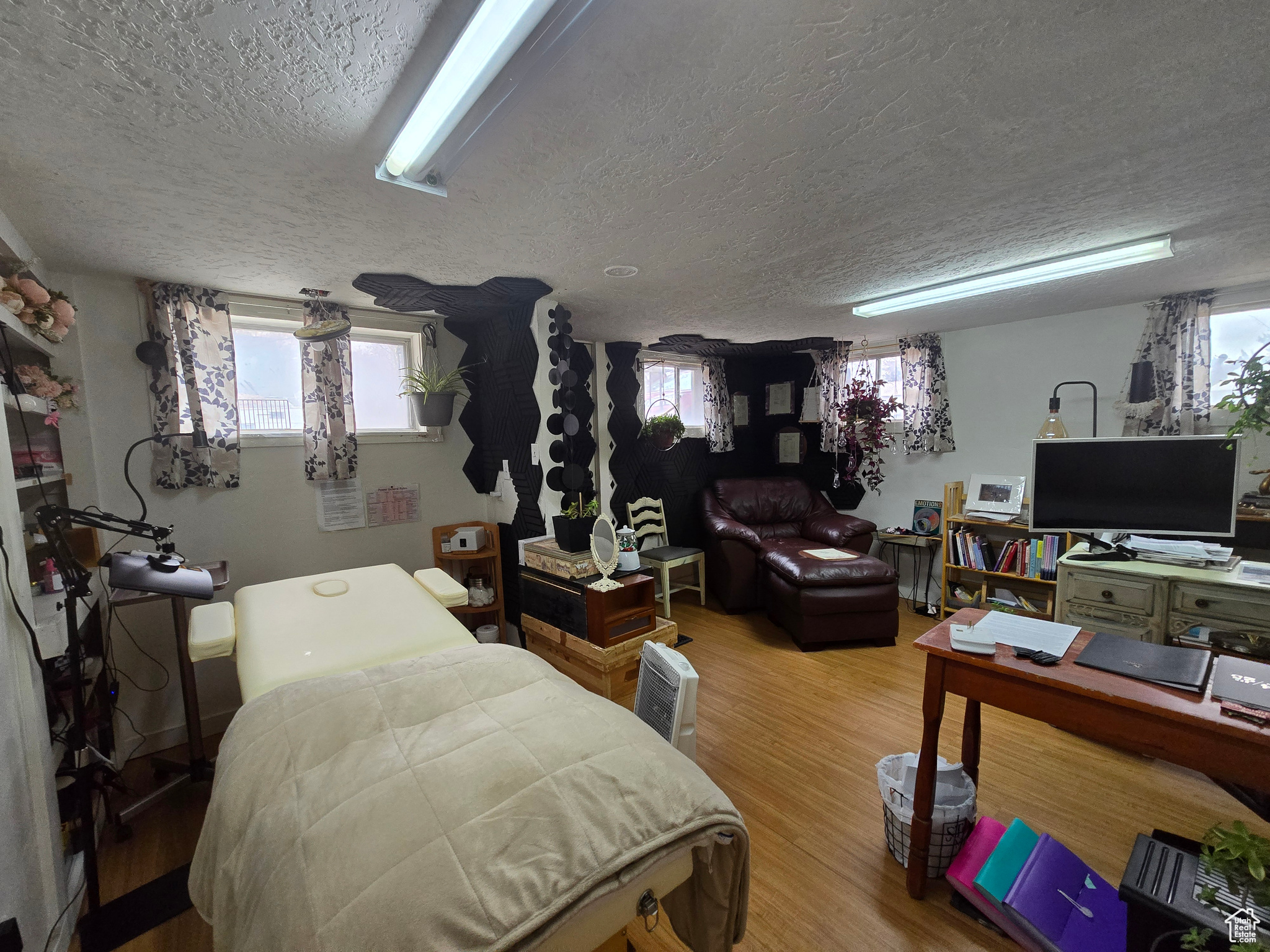Bedroom with hardwood / wood-style flooring and a textured ceiling