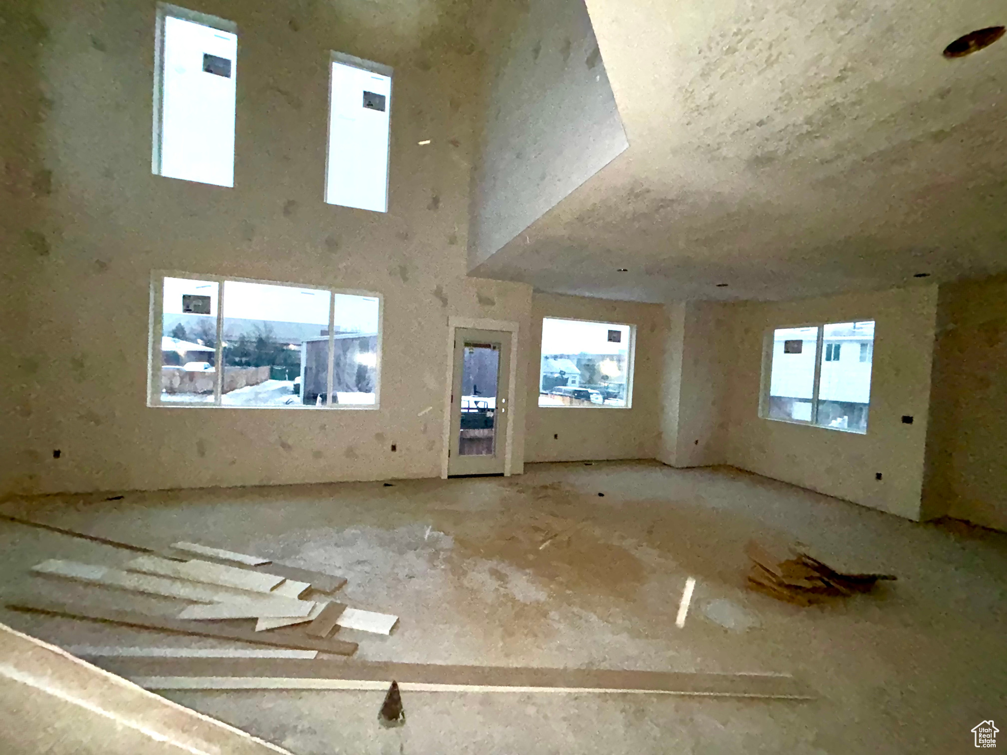 Empty room with a healthy amount of sunlight and a high ceiling