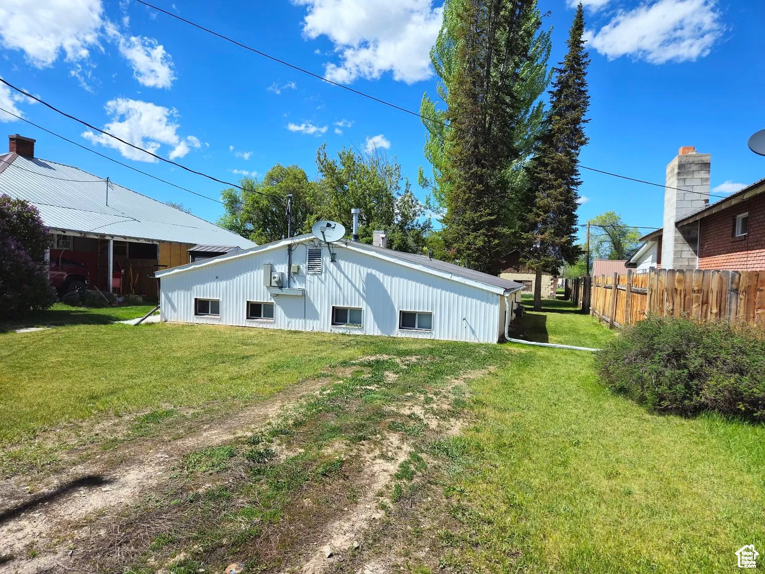 Rear view of property featuring a lawn