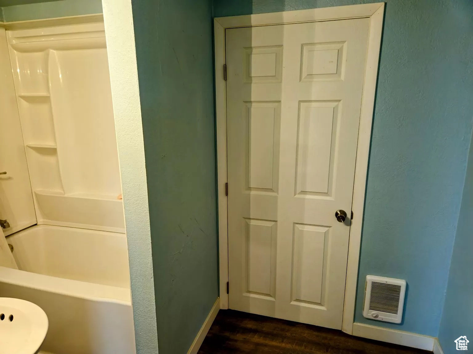 Bathroom featuring wood-type flooring and shower / tub combination