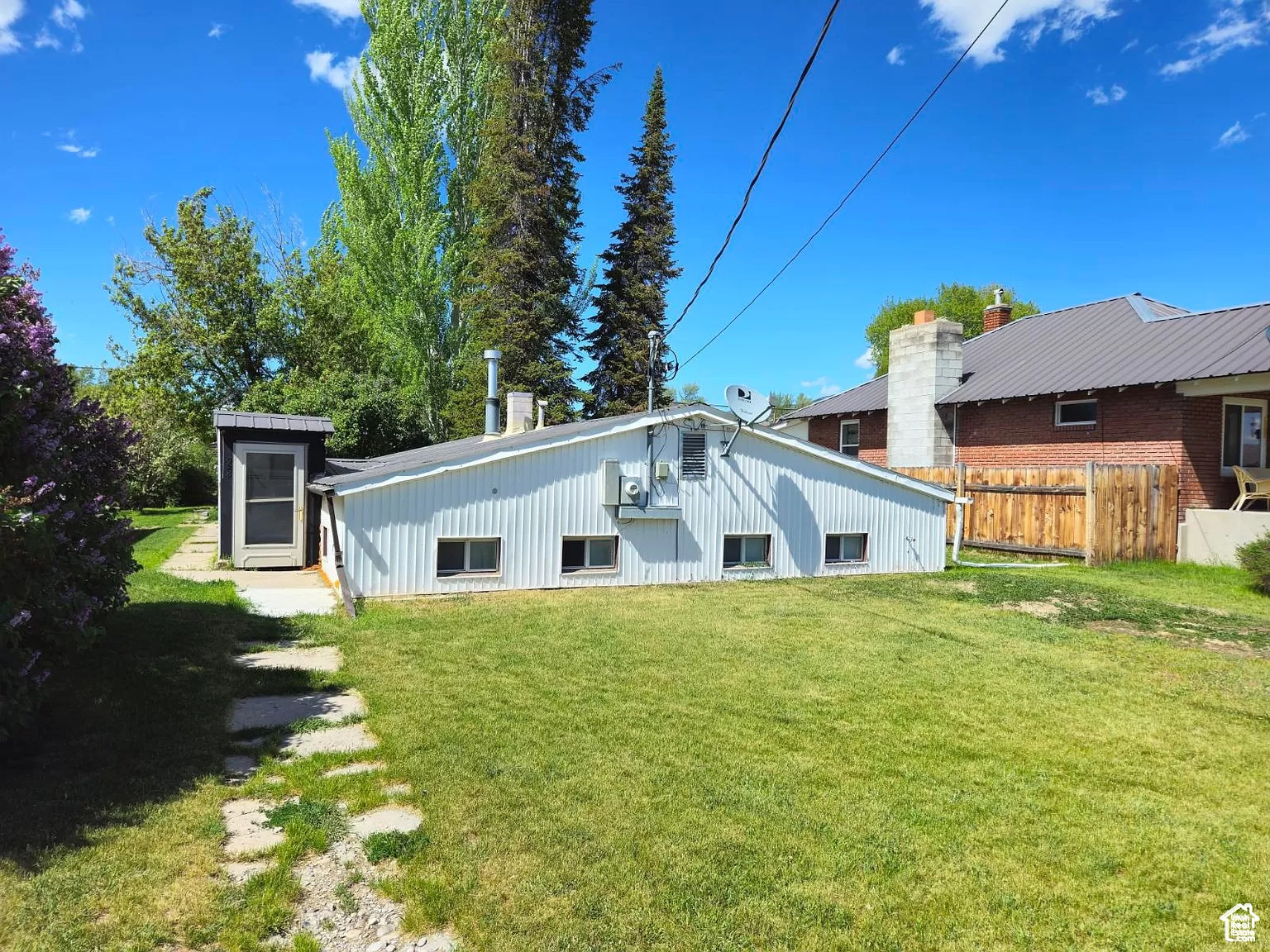 Rear view of house featuring a lawn
