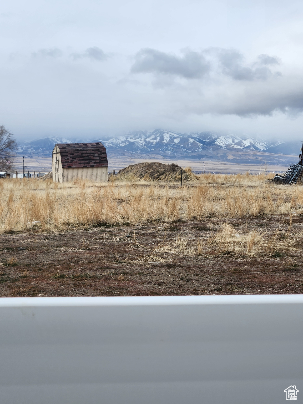 View of yard featuring a mountain view, a rural view, and a storage unit