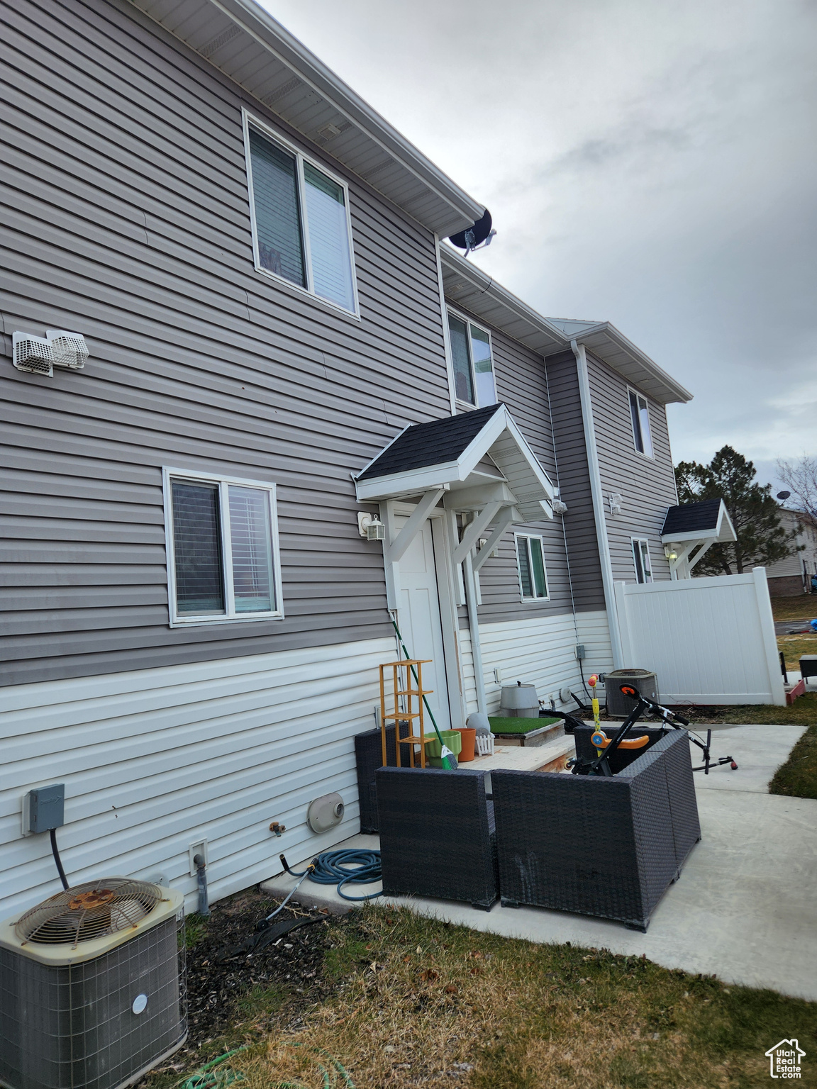Rear view of property featuring central AC unit, outdoor lounge area, and a patio