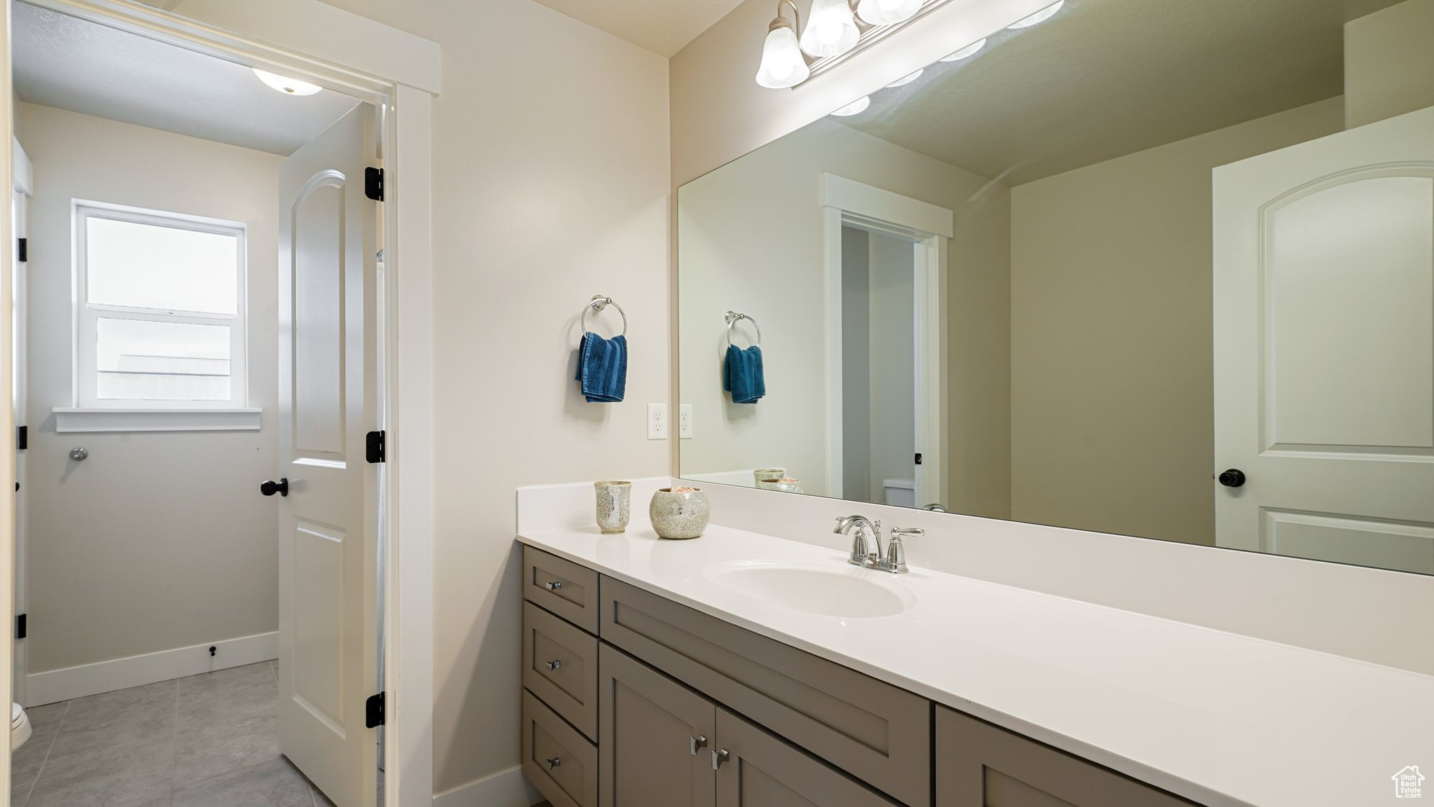 Full bathroom with tile patterned floors, vanity, and toilet