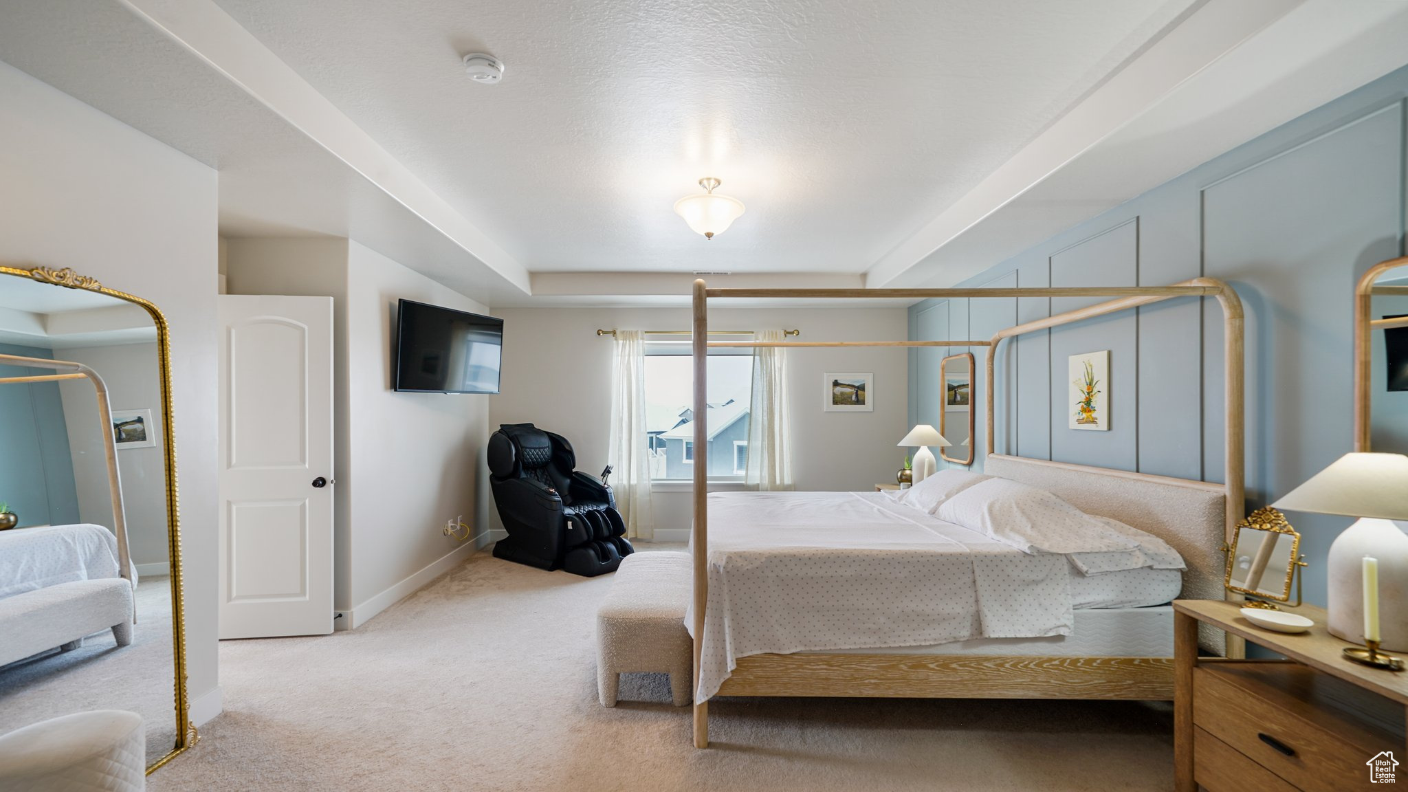 Carpeted Primary Bedroom featuring a raised ceiling