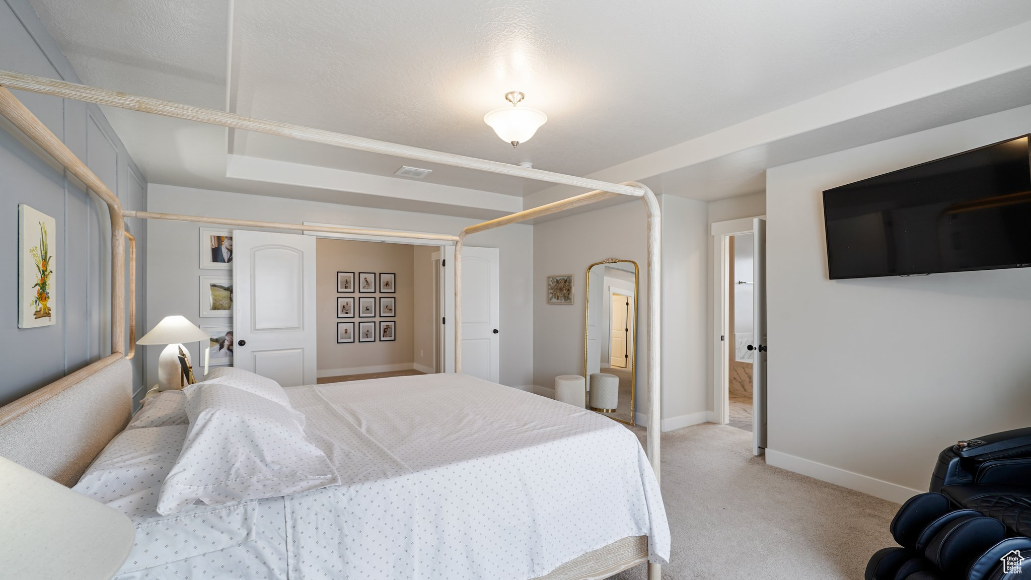 Primary Bedroom with light colored carpet