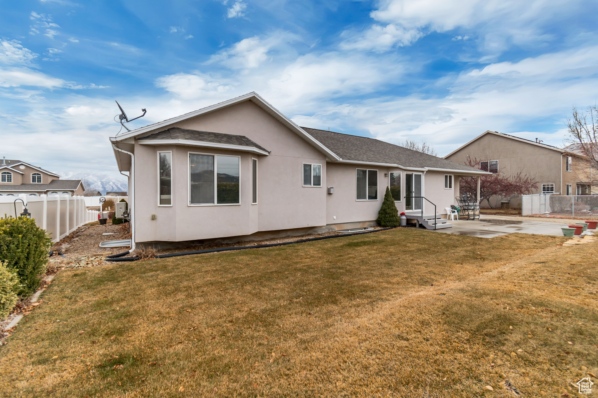 Back of property with a yard and a patio area