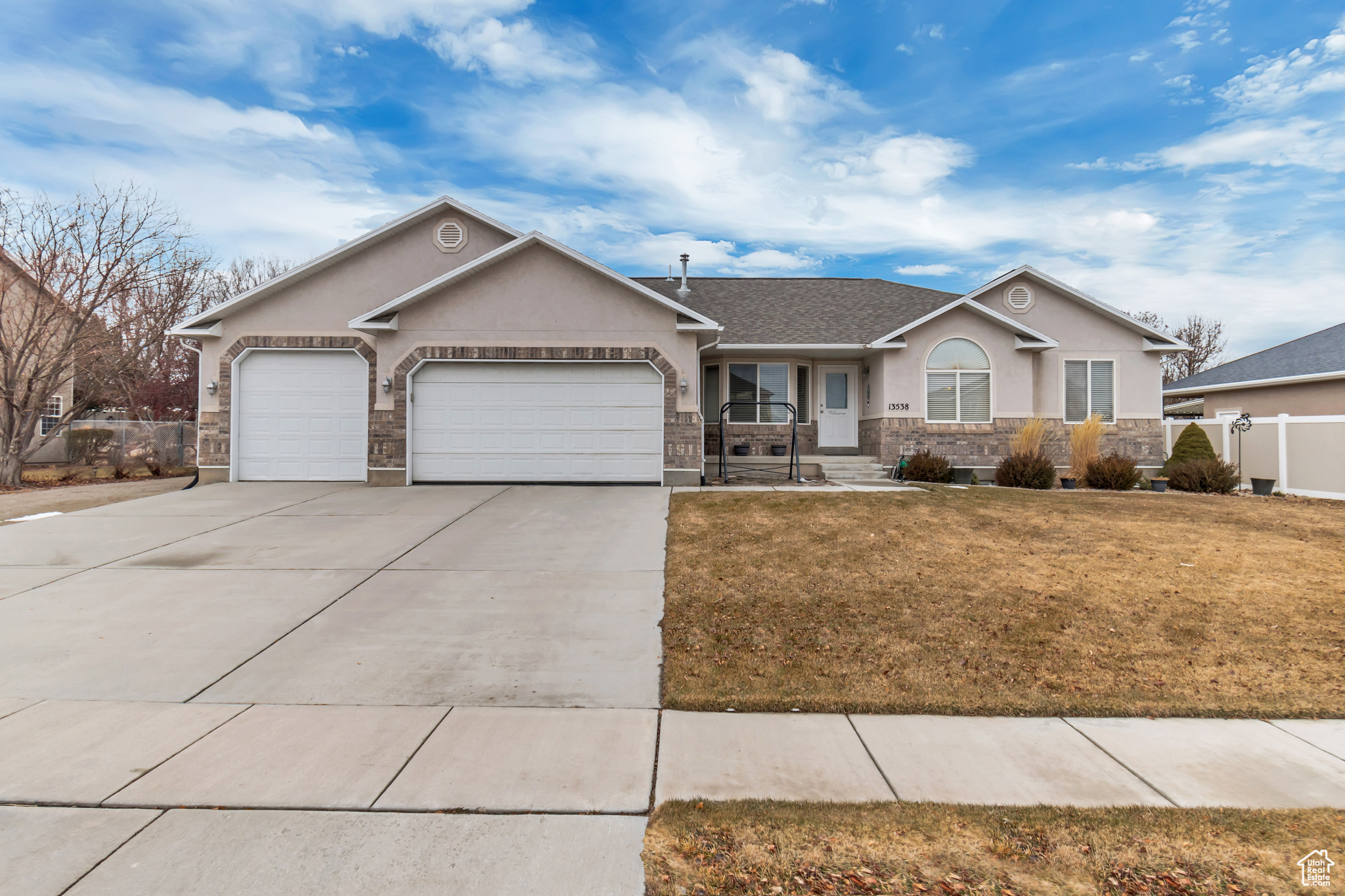Ranch-style house with a garage and a front yard