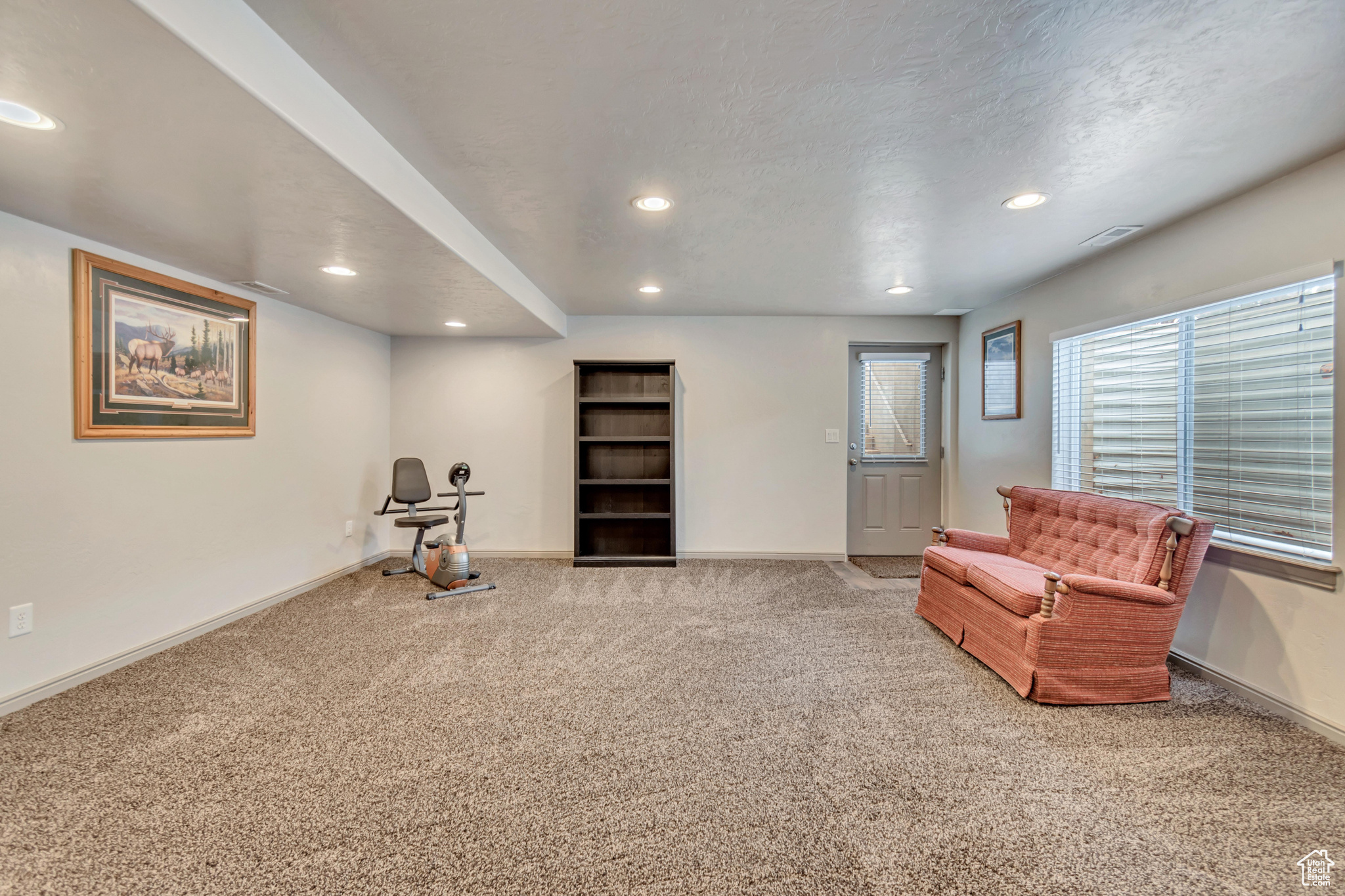 Living area featuring carpet floors and a textured ceiling