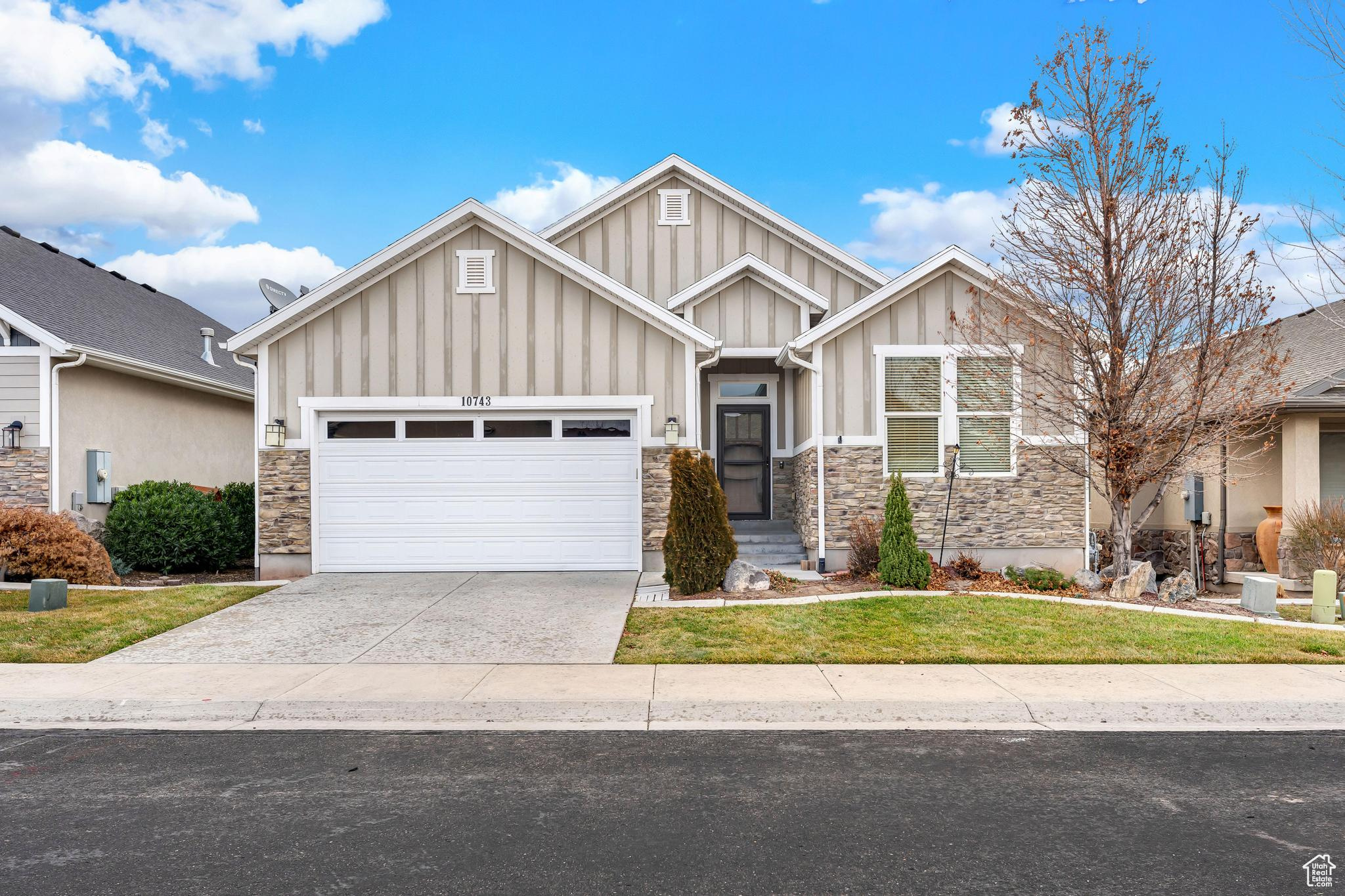 Welcoming entrance and mature landscaping.  Windowed garage