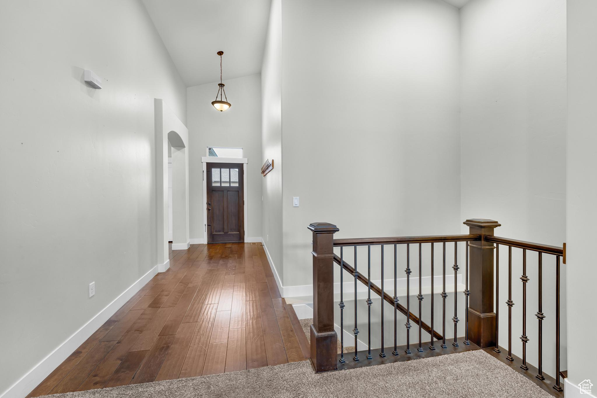 Entrance with high vaulted ceiling and engineered wood flooring