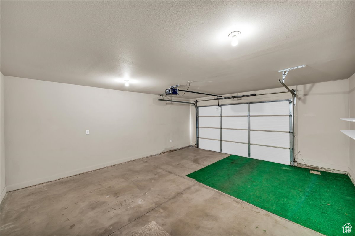 Garage featuring a garage door opener