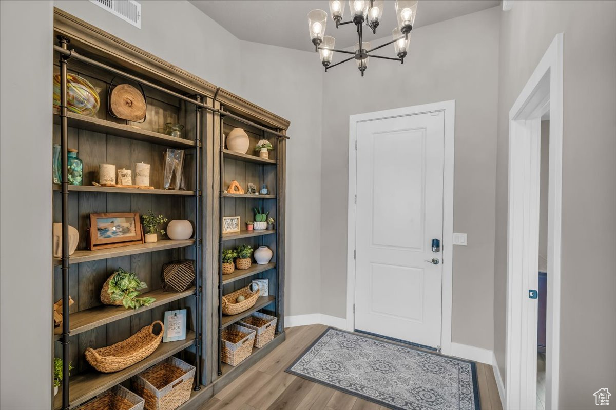 Interior space featuring hardwood / wood-style flooring and a chandelier
