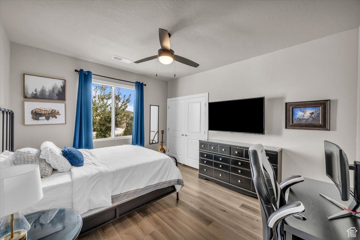 Bedroom featuring ceiling fan and light hardwood / wood-style floors