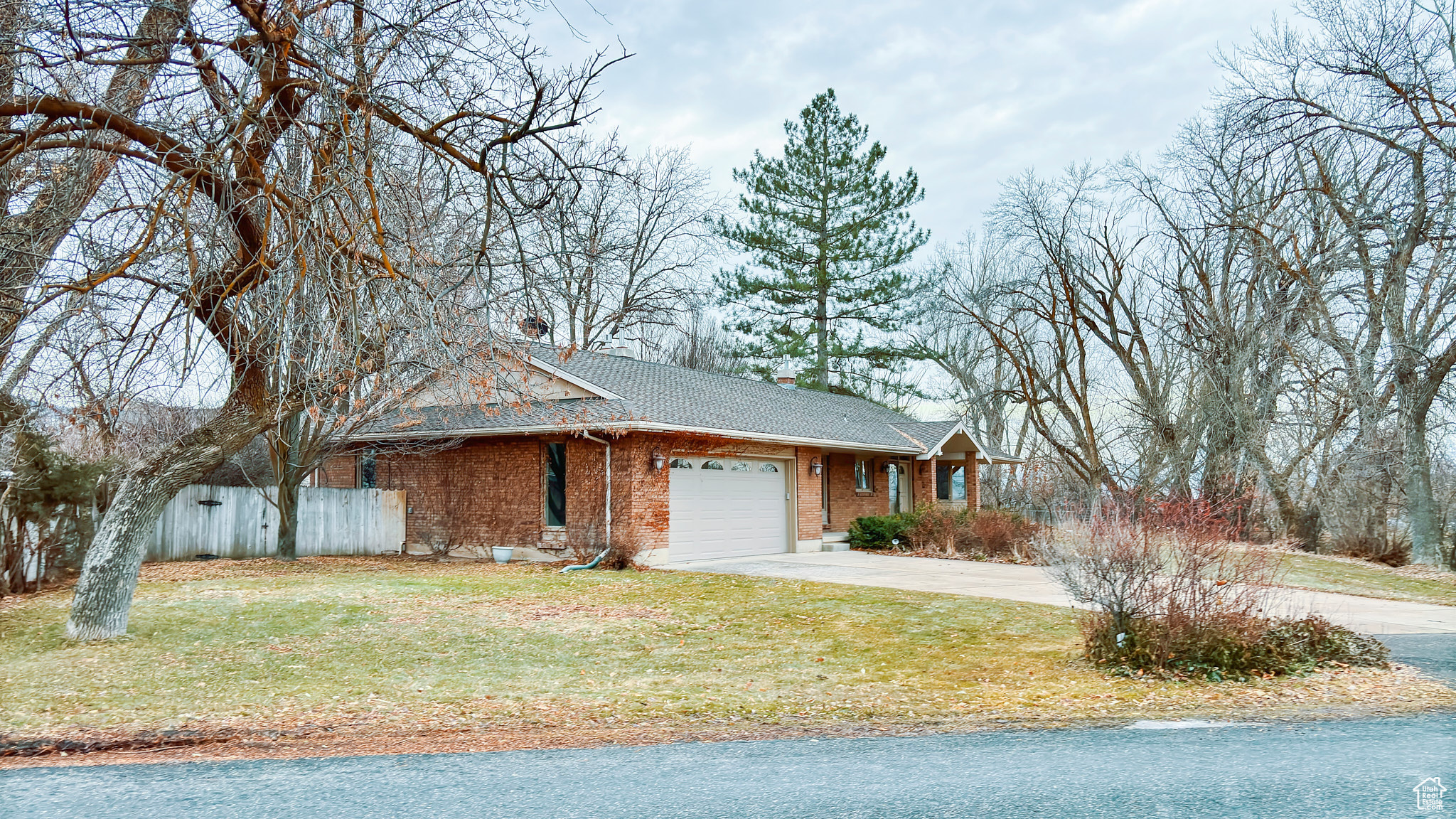 View of front of house featuring a garage and a front yard