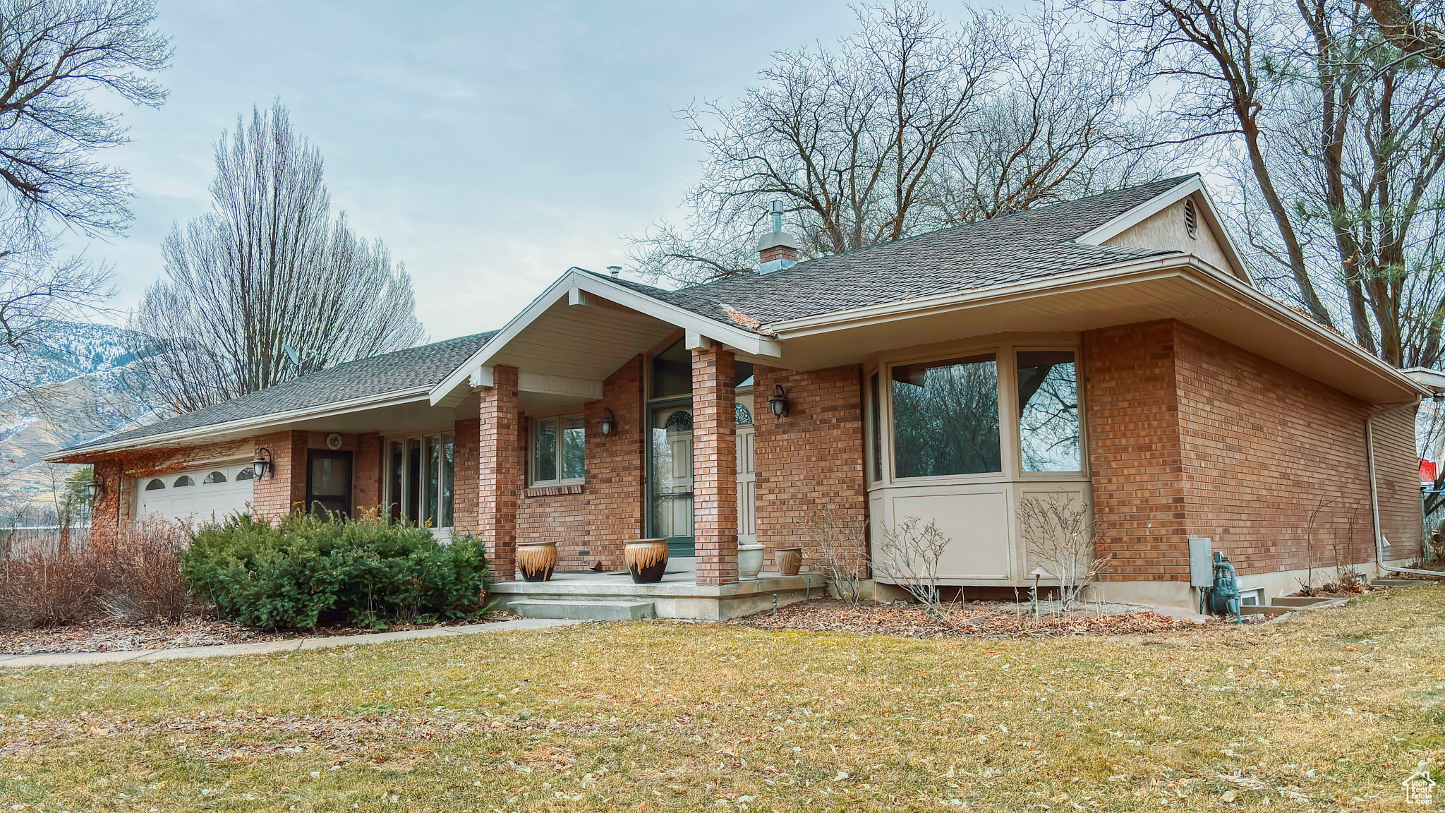 View of front of house featuring a garage and a front lawn
