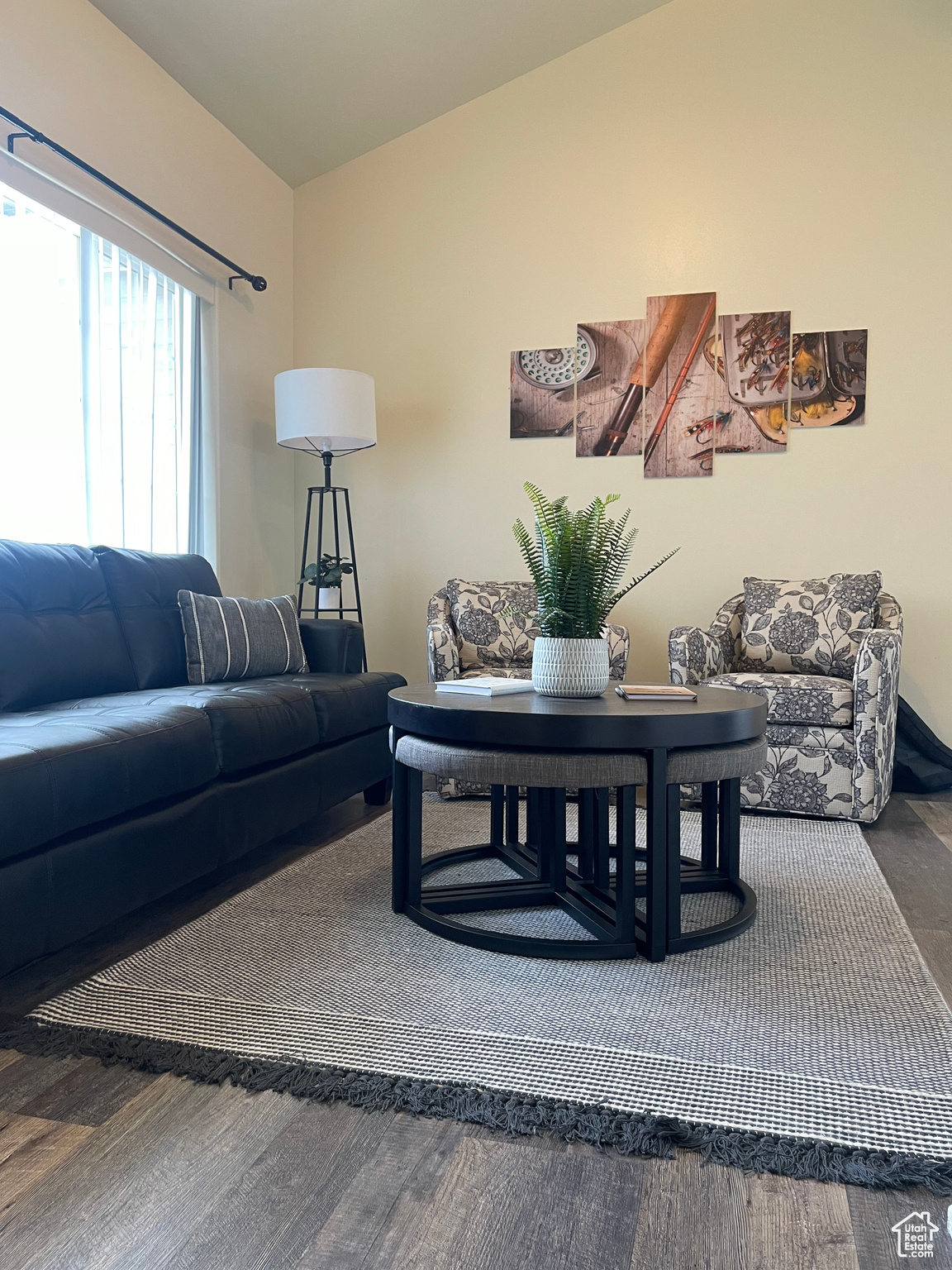 Living room featuring vaulted ceiling and wood-type flooring