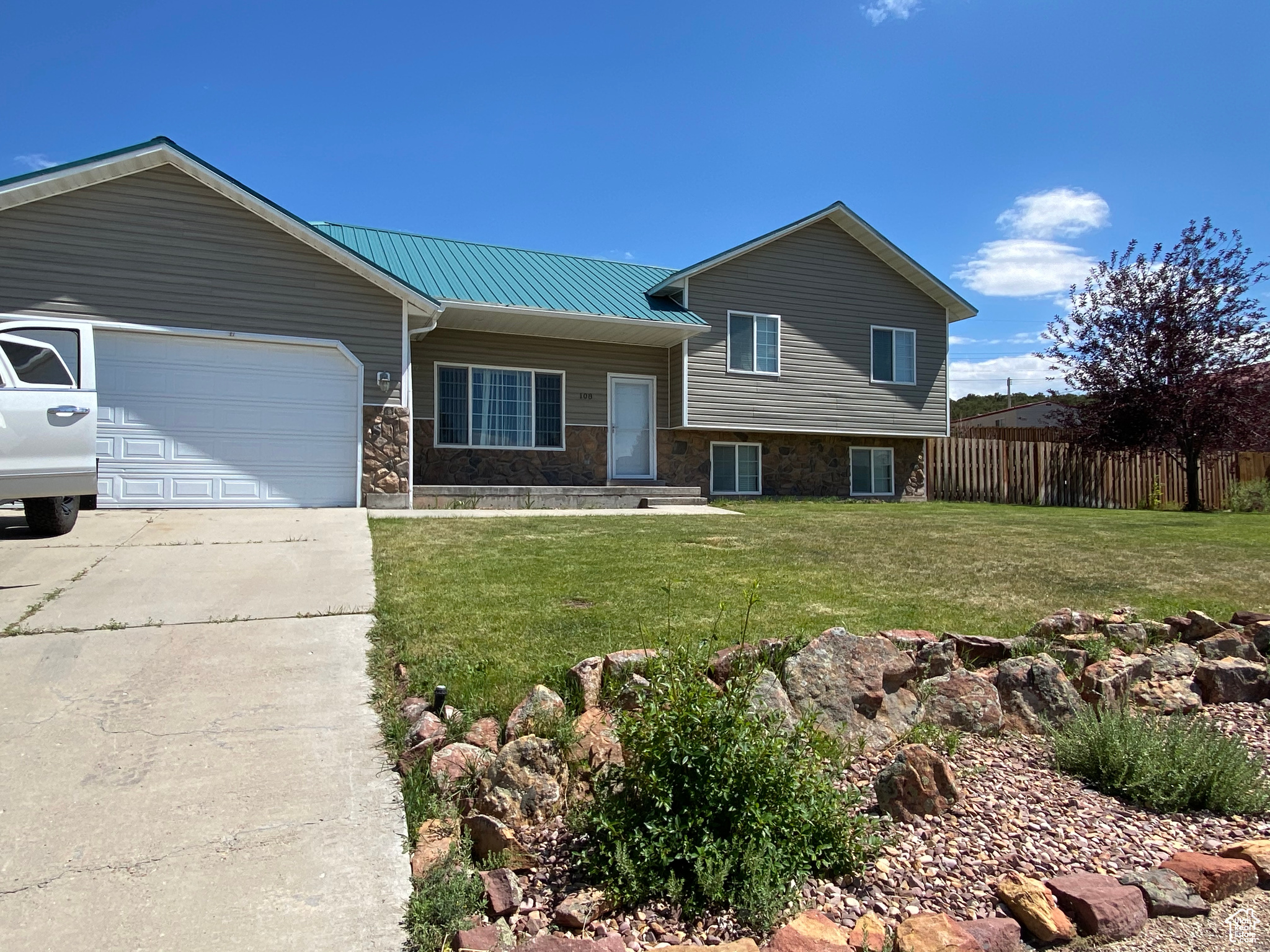 View of front of home with a garage and a front yard