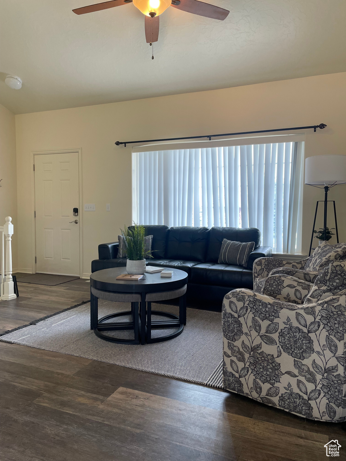 Living room with dark wood-type flooring and ceiling fan