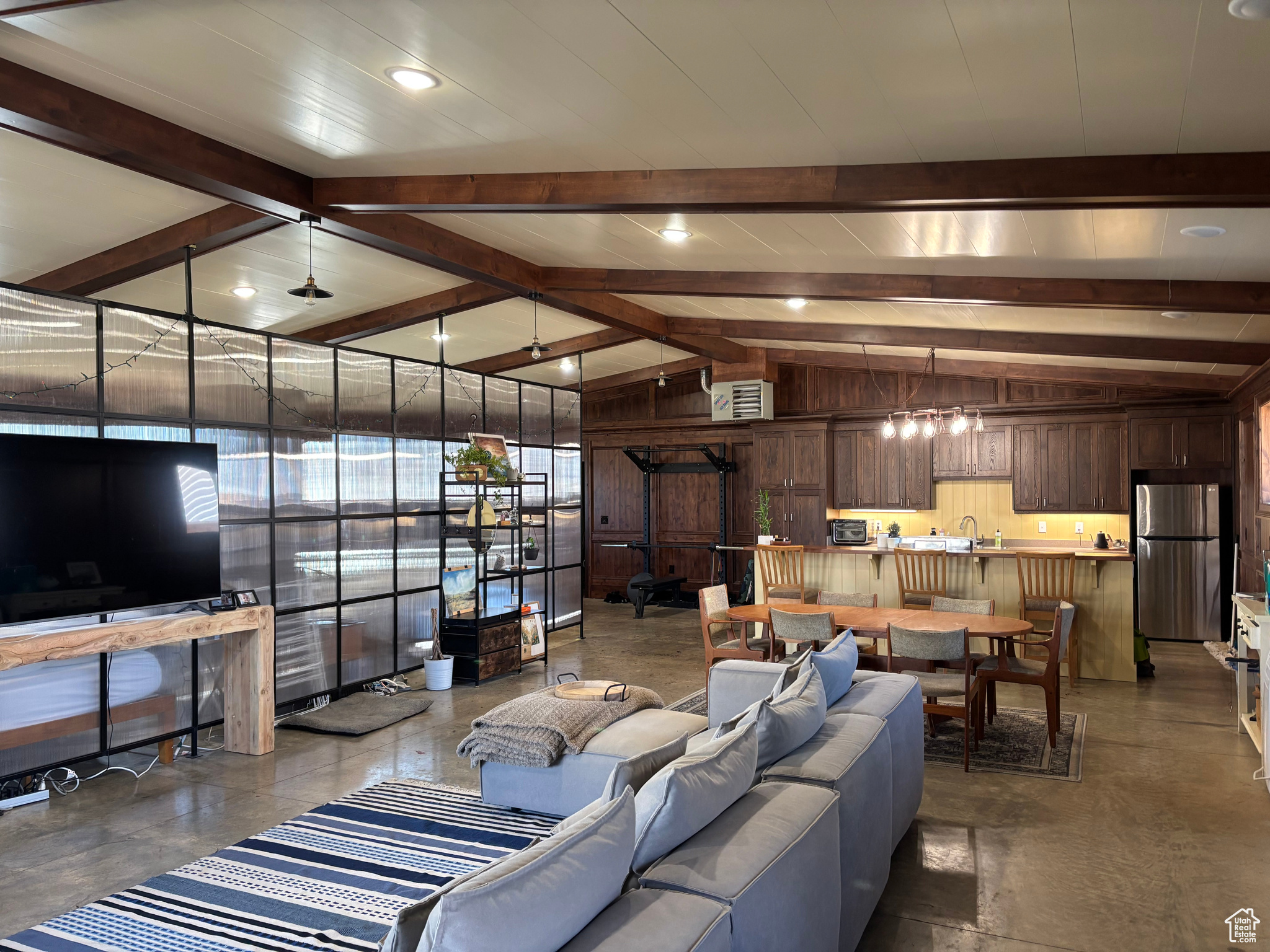 Living room featuring lofted ceiling with beams