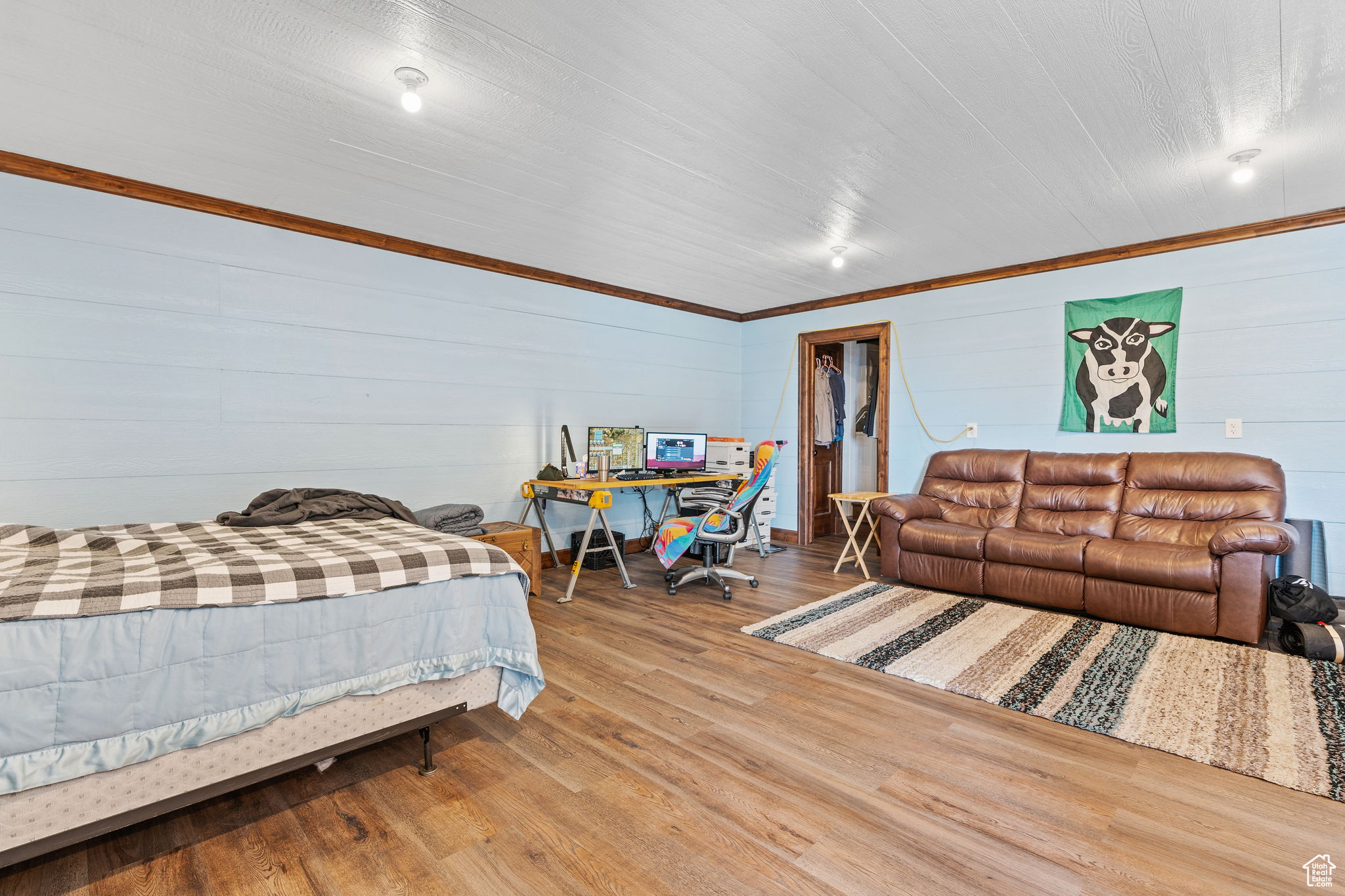 Bedroom featuring hardwood / wood-style flooring and a spacious closet