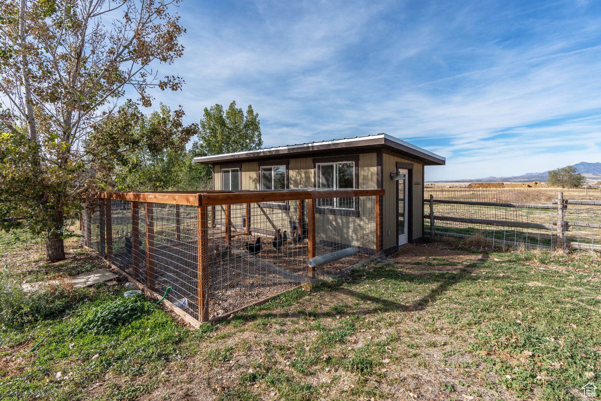 View of outbuilding featuring a lawn and a rural view