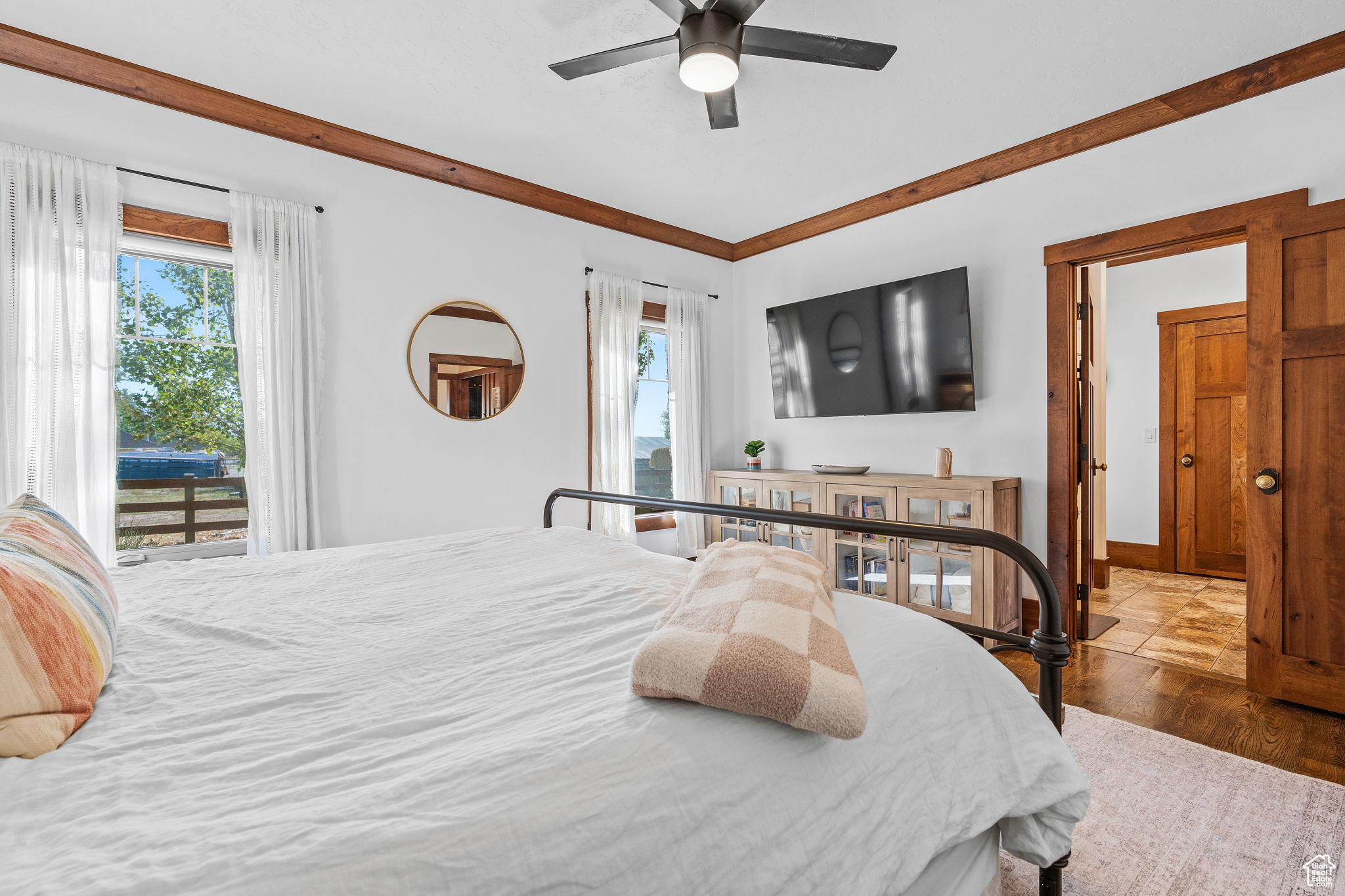 Bedroom featuring access to exterior, hardwood / wood-style floors, and ceiling fan