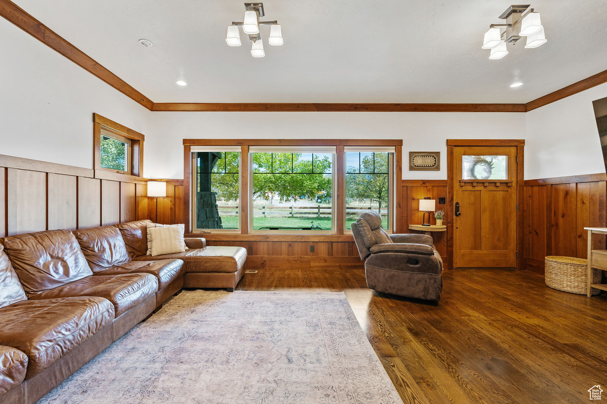 Living room with crown molding and dark hardwood / wood-style floors