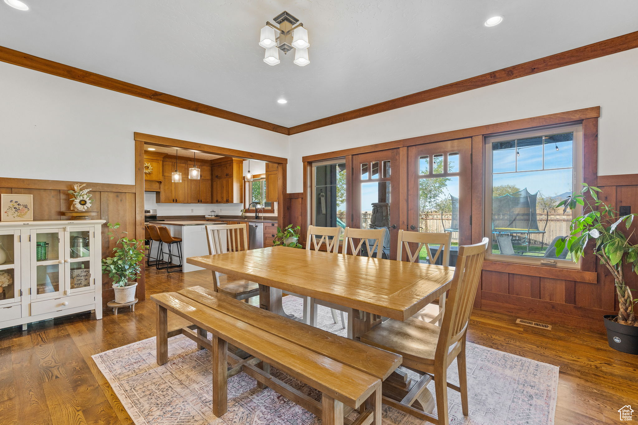 Dining area with crown molding and dark hardwood / wood-style floors