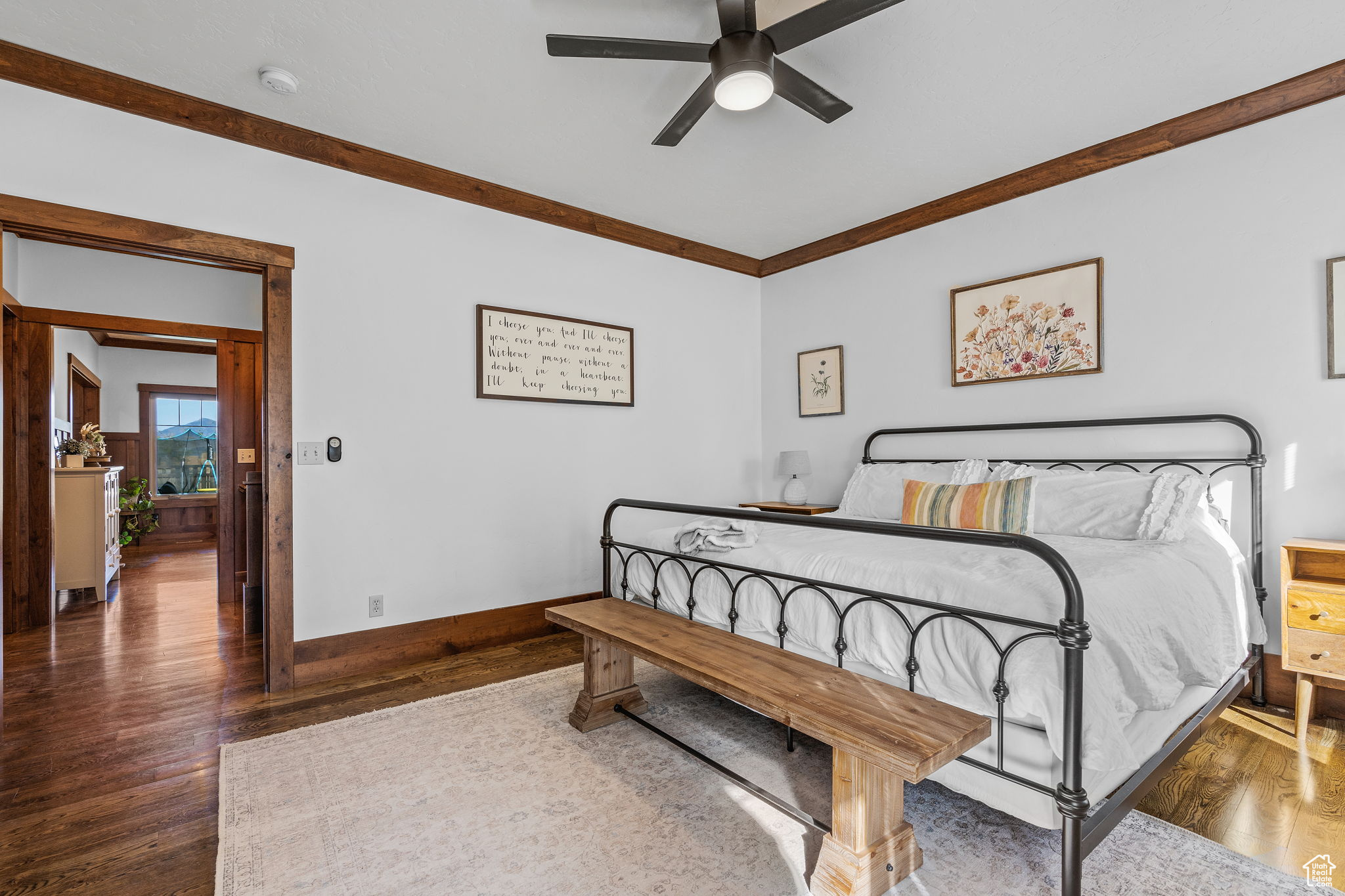 Bedroom featuring crown molding, dark hardwood / wood-style floors, and ceiling fan