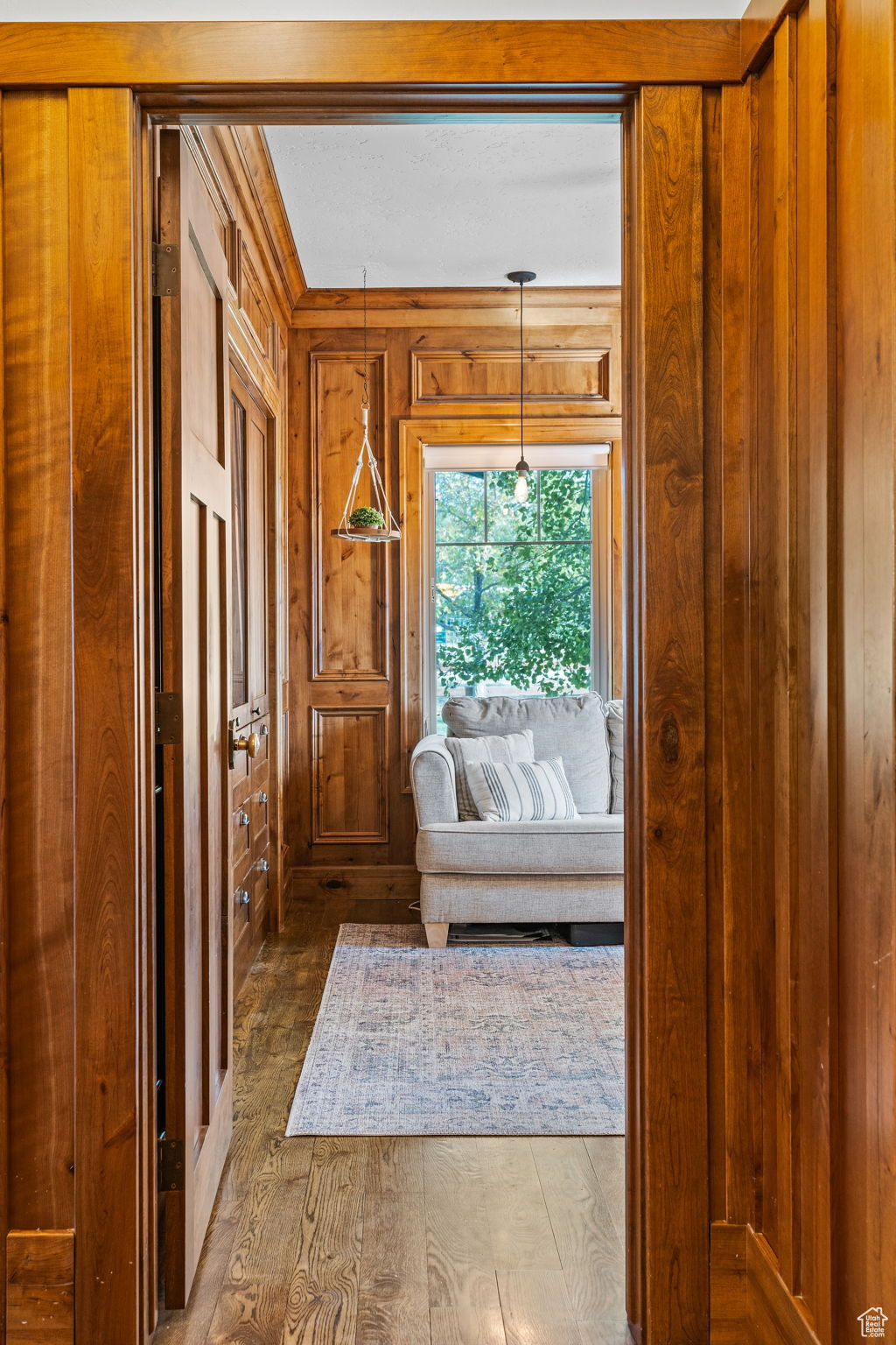 Interior space with hardwood / wood-style flooring and wood walls