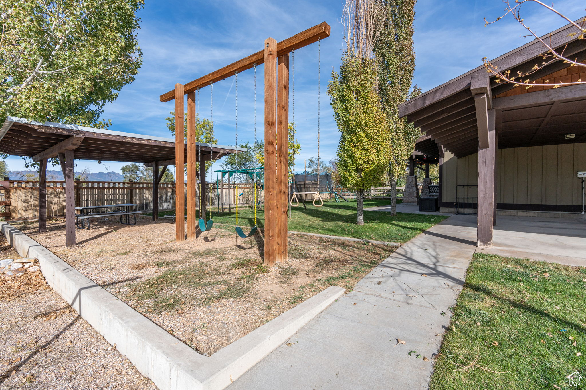 View of yard featuring a playground and a trampoline