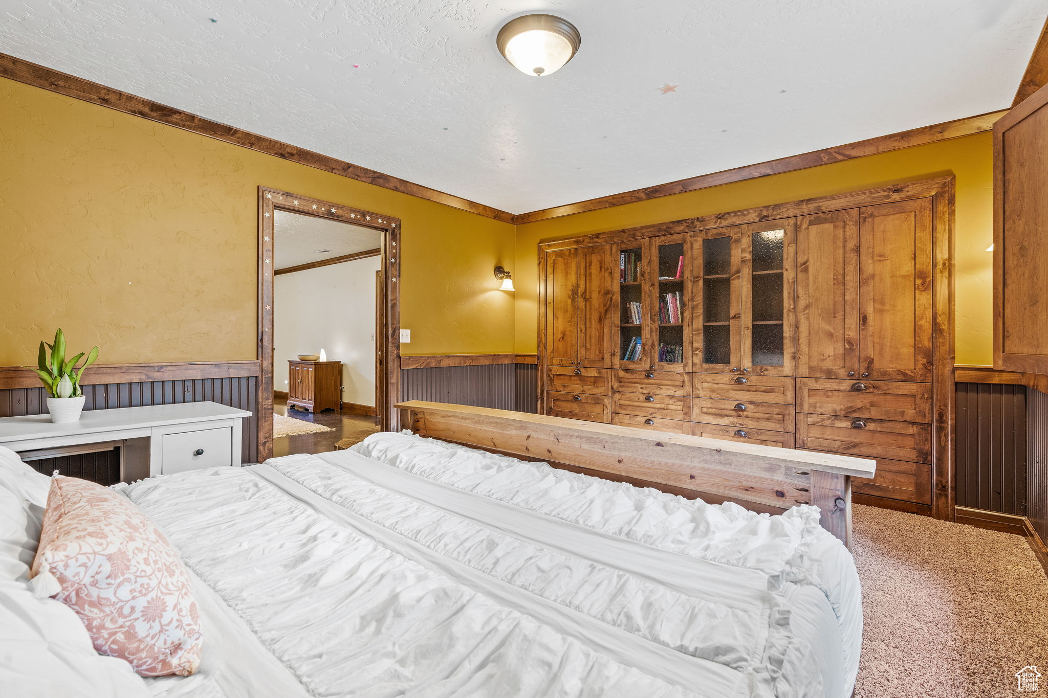 Carpeted bedroom with crown molding