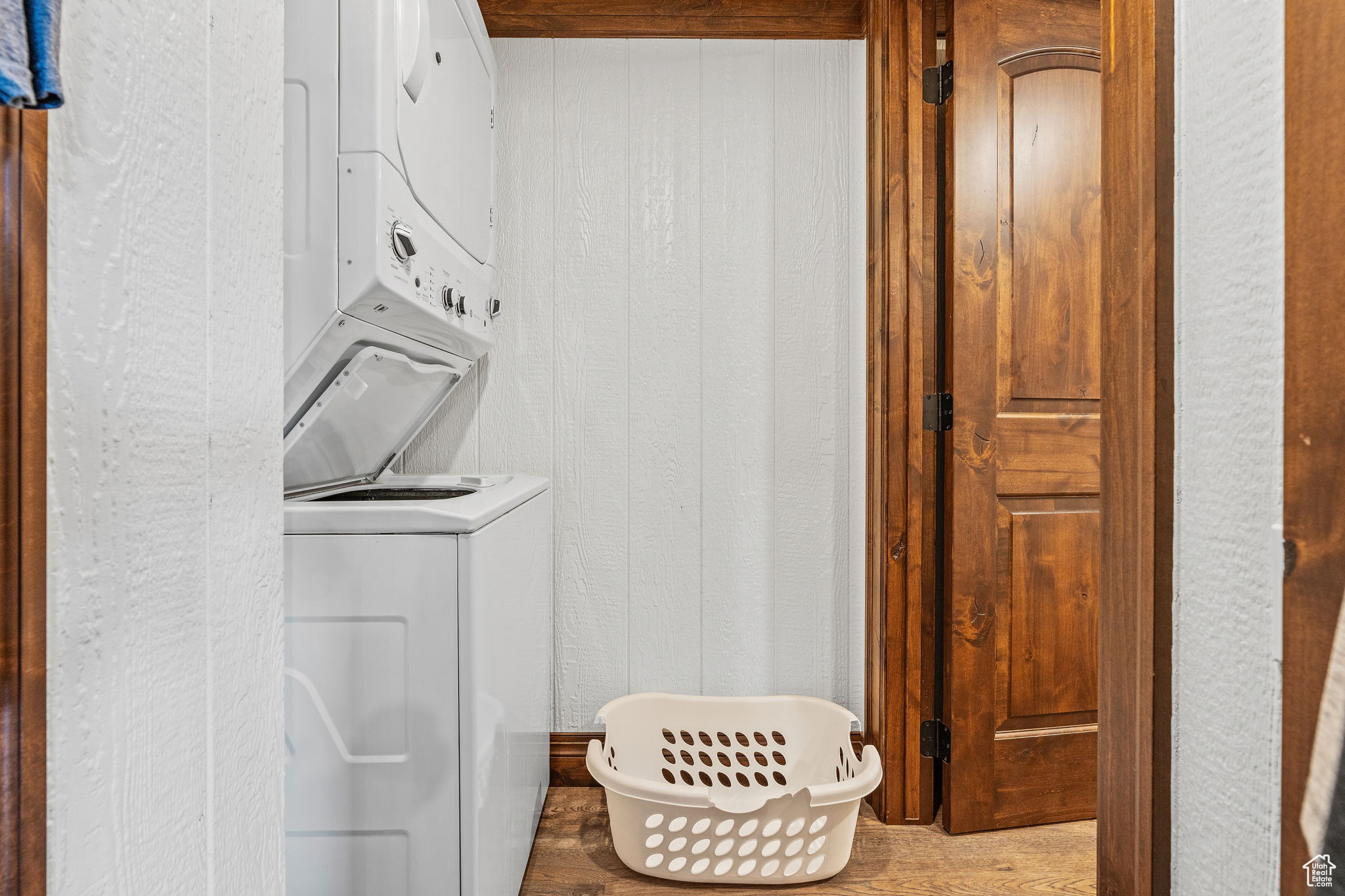 Laundry room featuring stacked washer and dryer