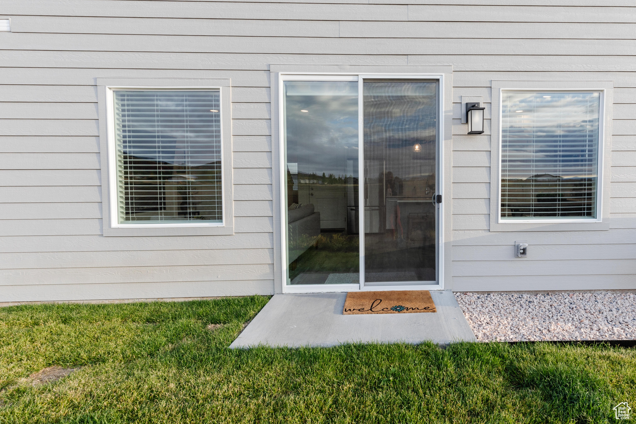 View of exterior entry featuring a yard