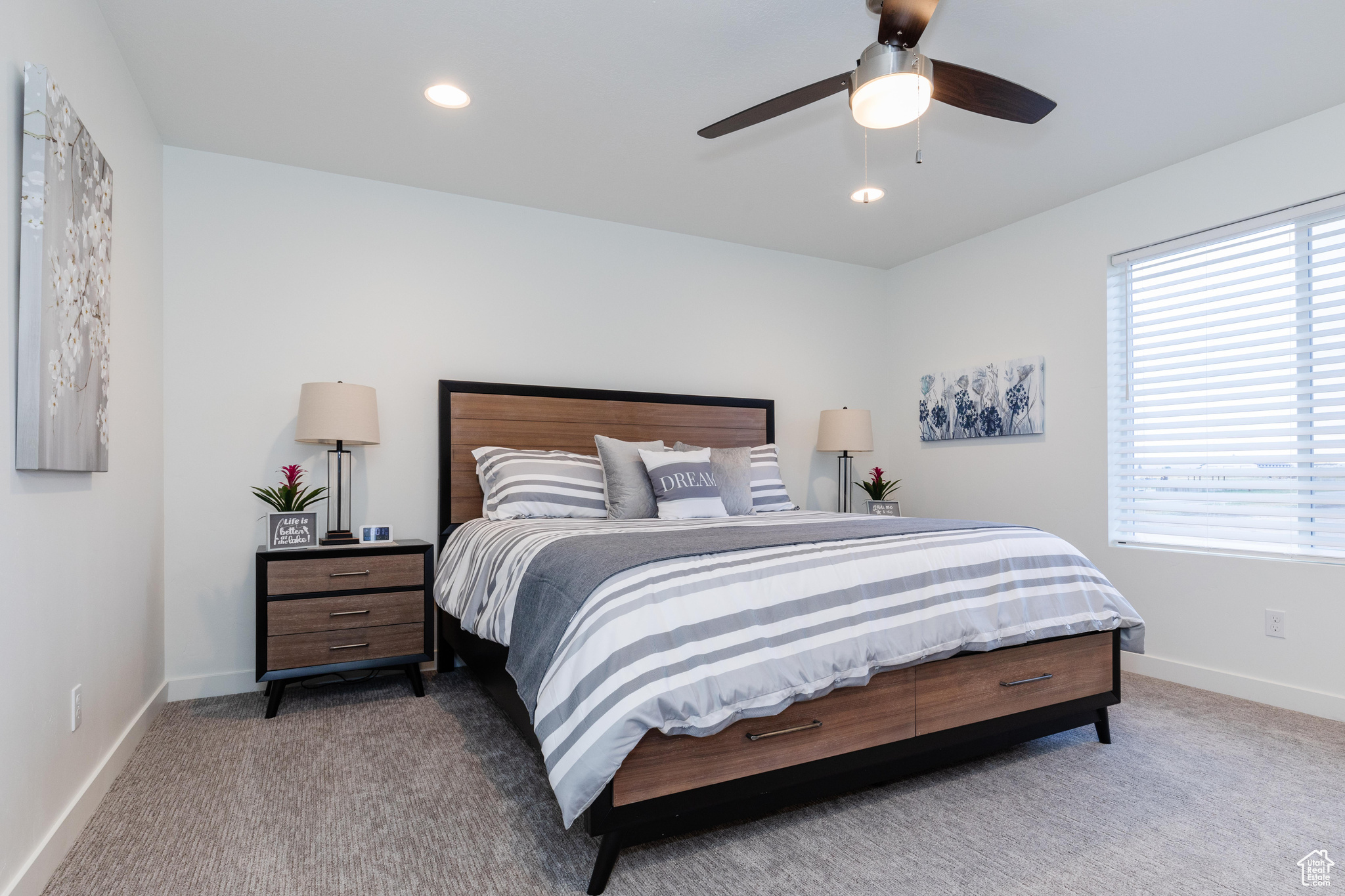 Carpeted bedroom with ceiling fan