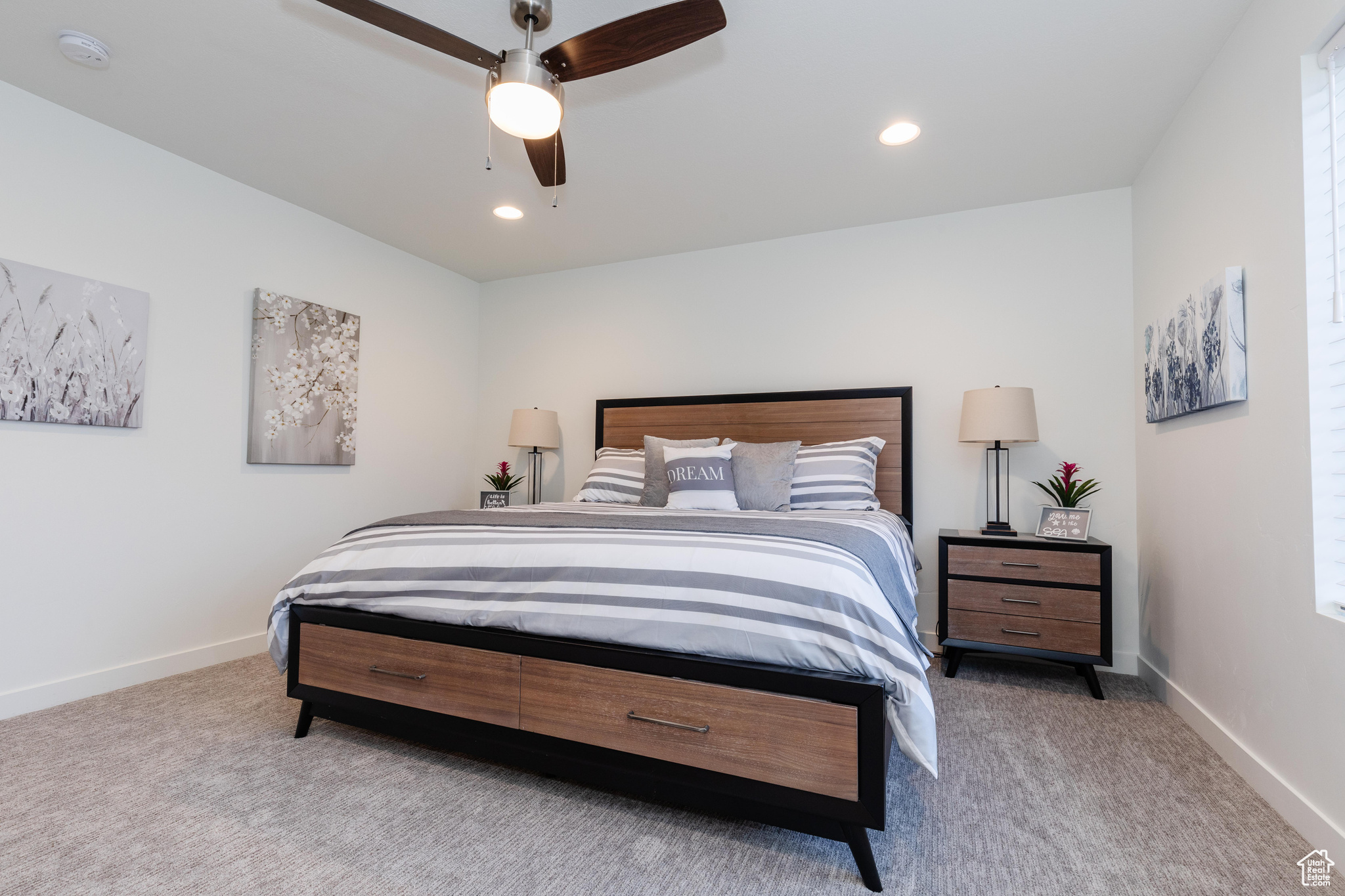 Carpeted bedroom featuring ceiling fan