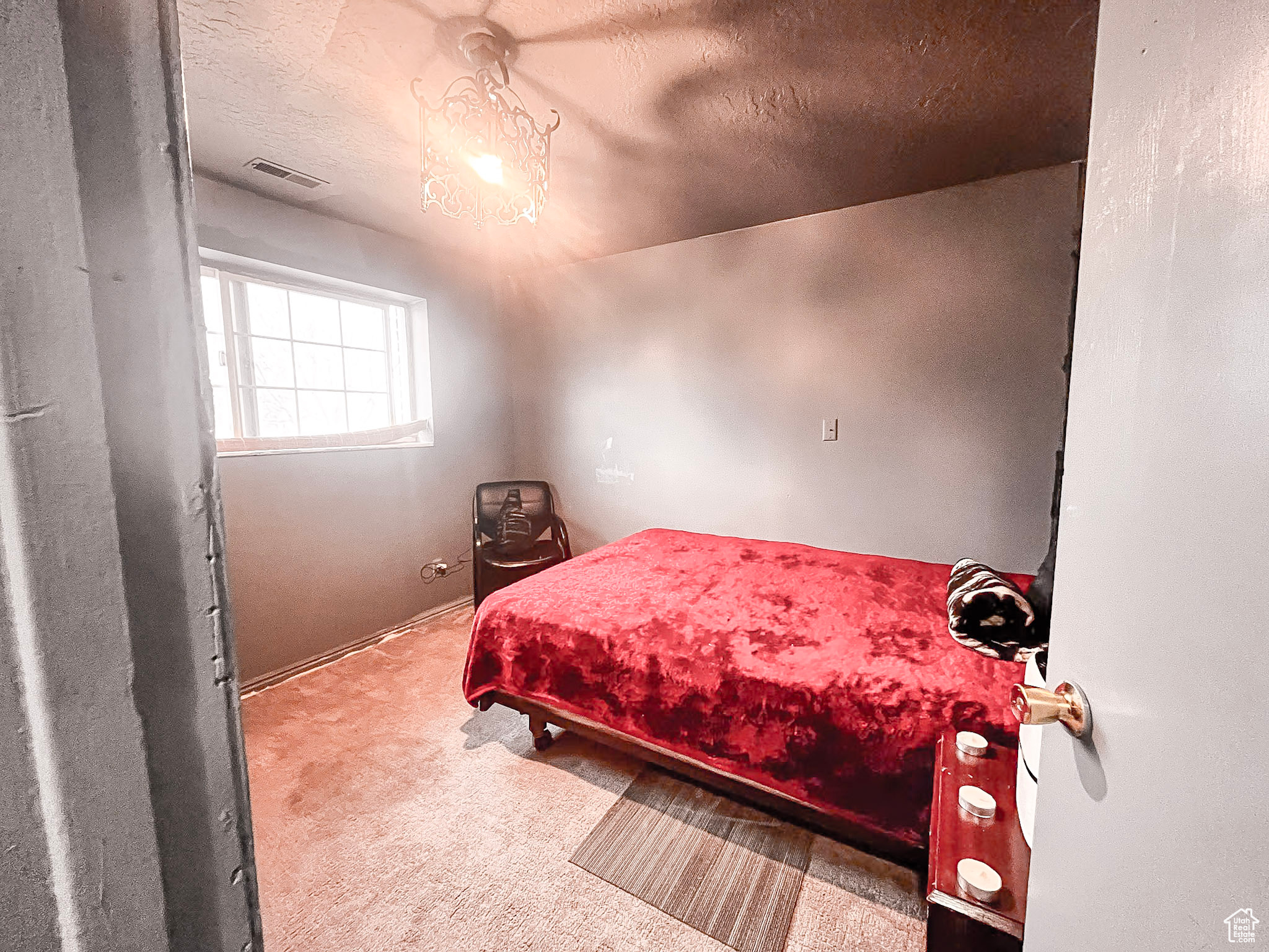 Bedroom featuring a textured ceiling and carpet