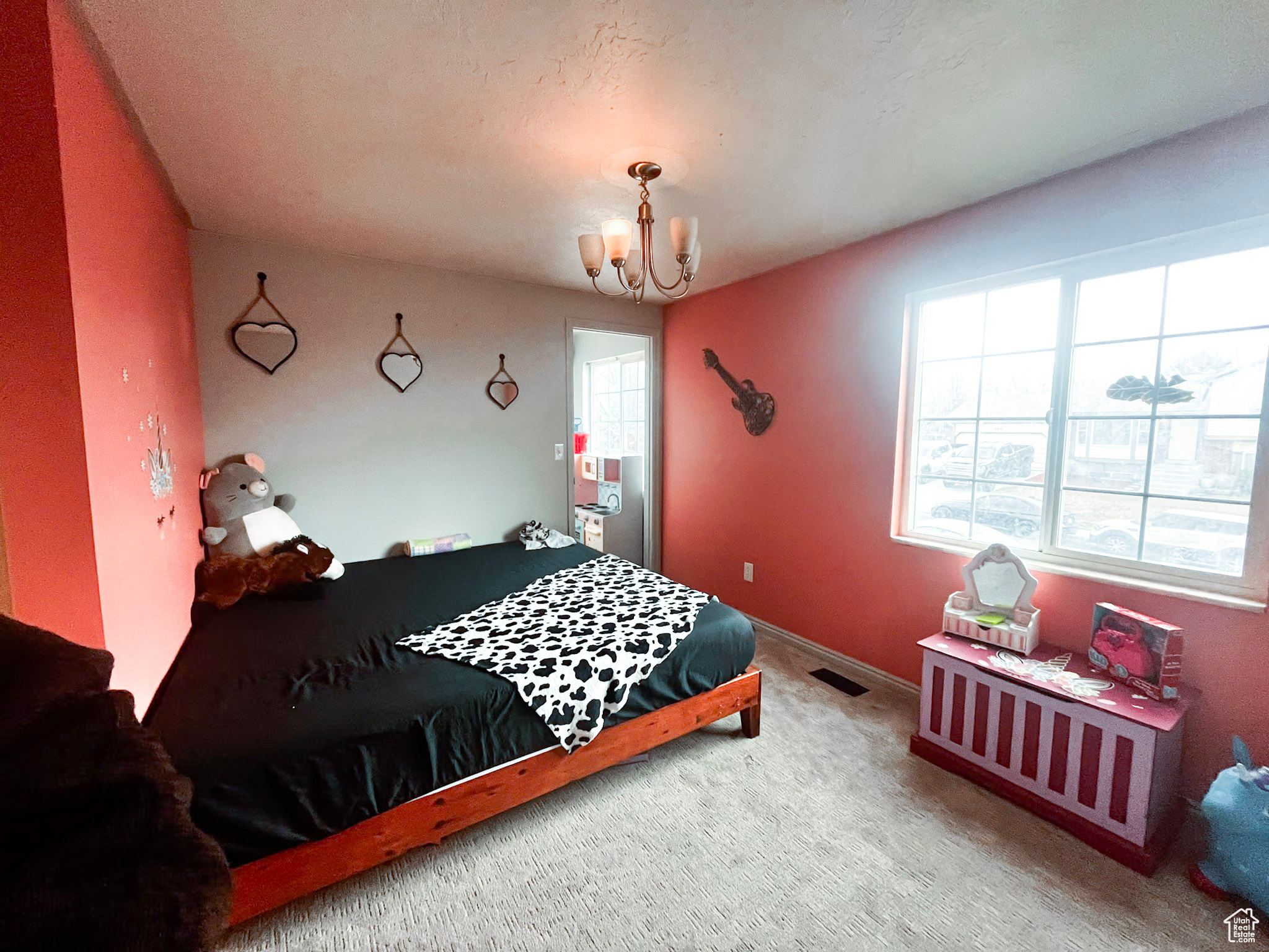 Bedroom featuring carpet flooring and a chandelier