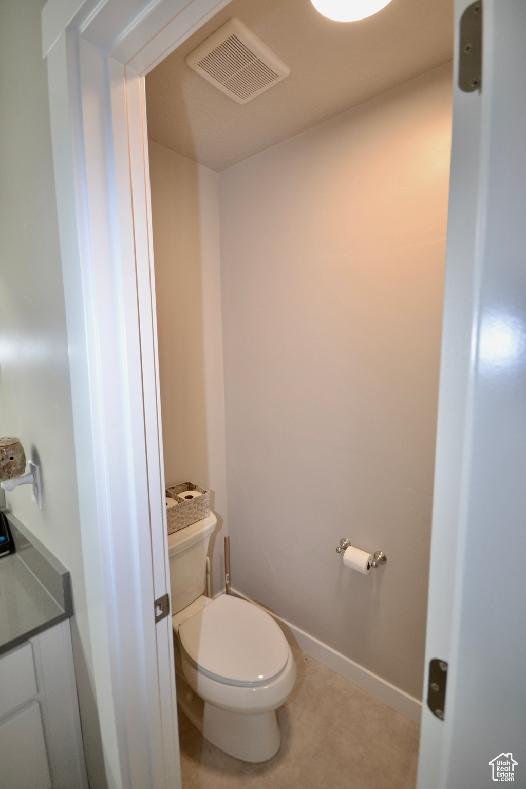 Bathroom featuring tile patterned floors and toilet