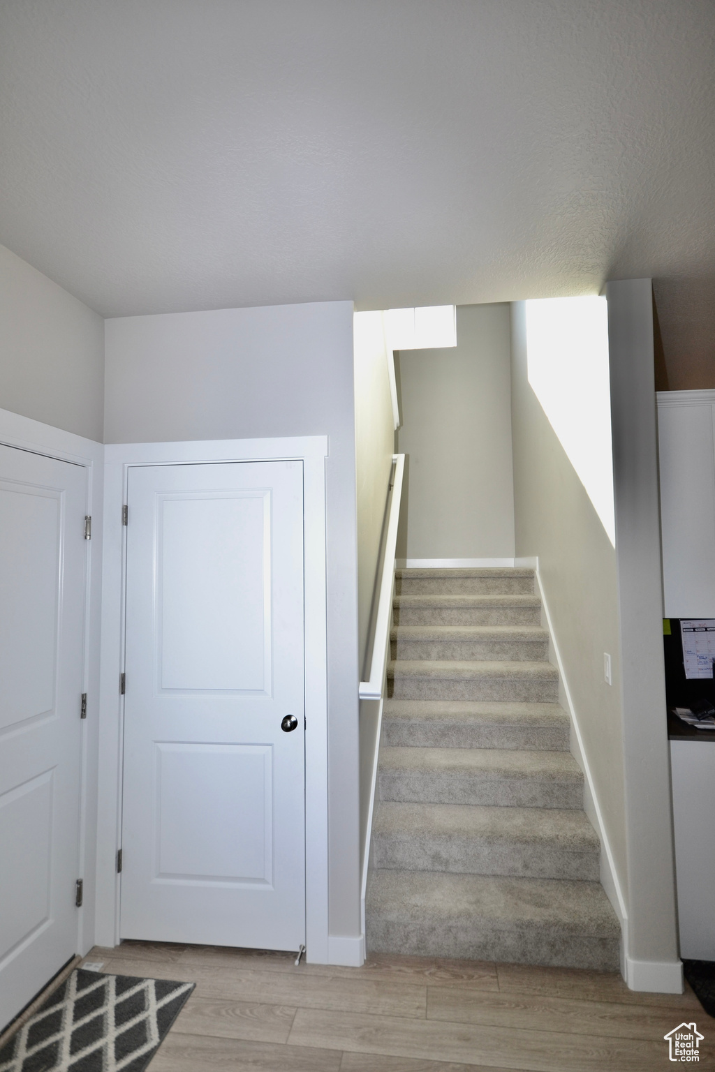 Stairway featuring hardwood / wood-style floors