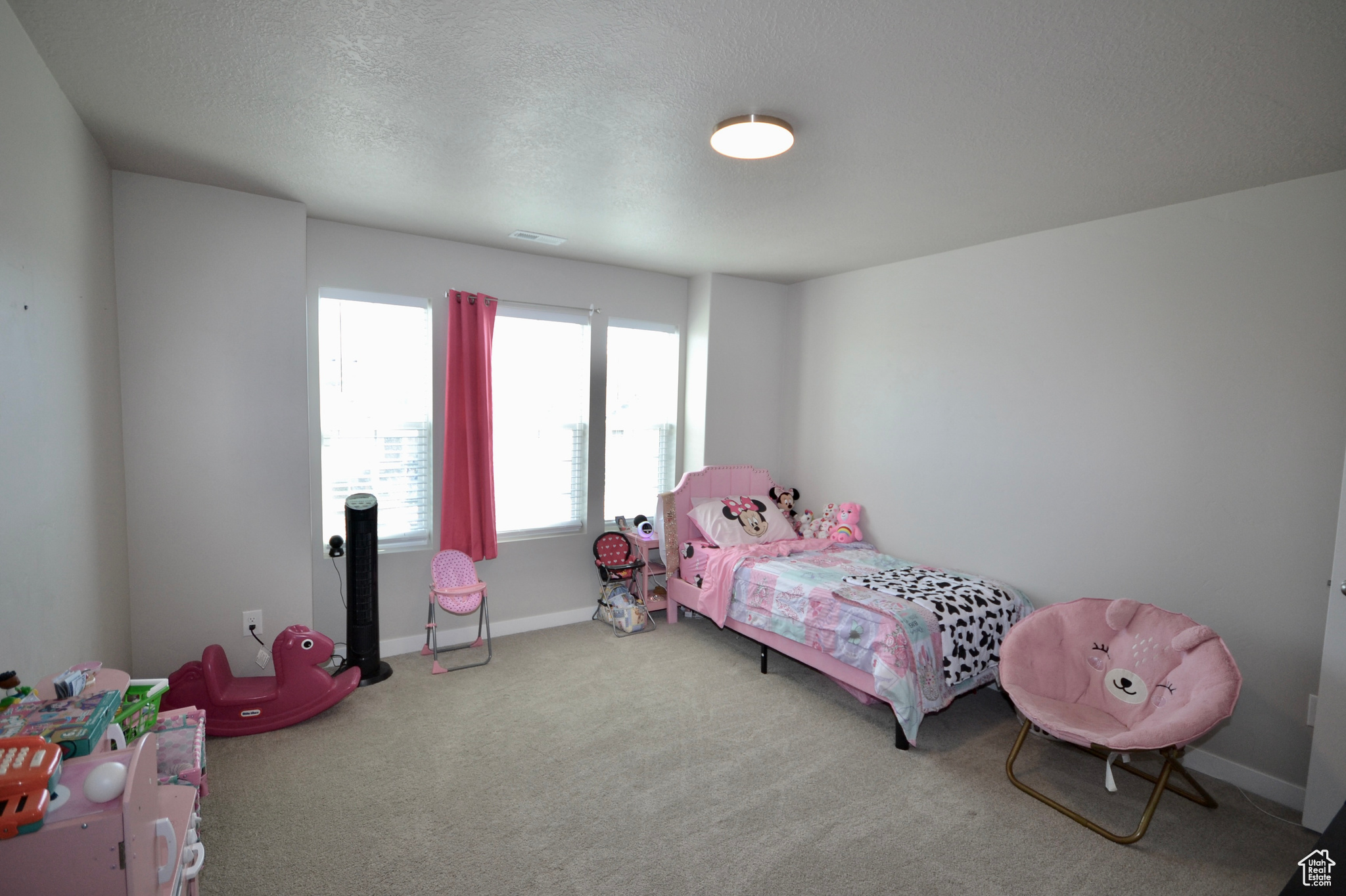 Bedroom featuring a textured ceiling and carpet flooring