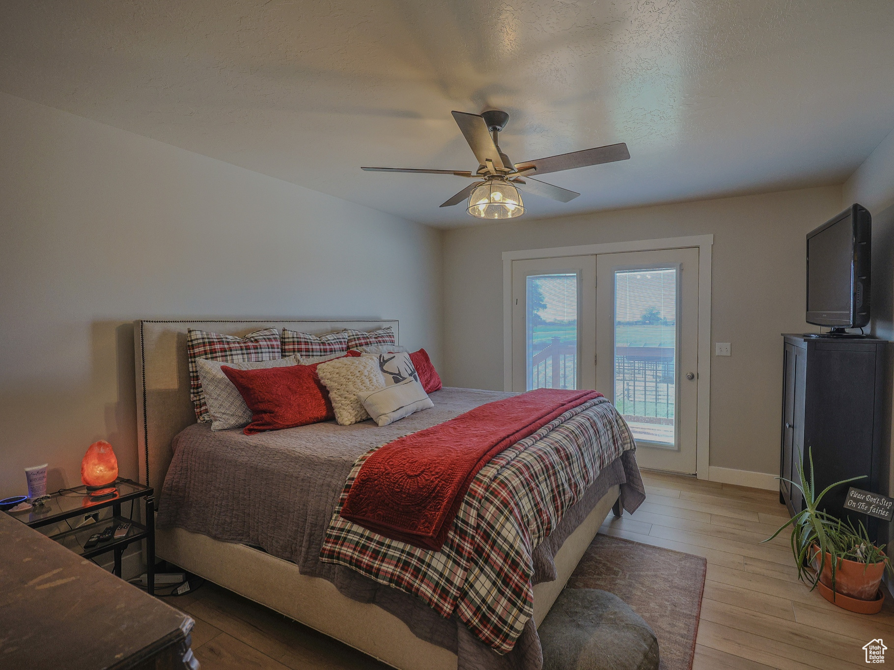 Bedroom featuring ceiling fan, light hardwood / wood-style flooring, and access to outside